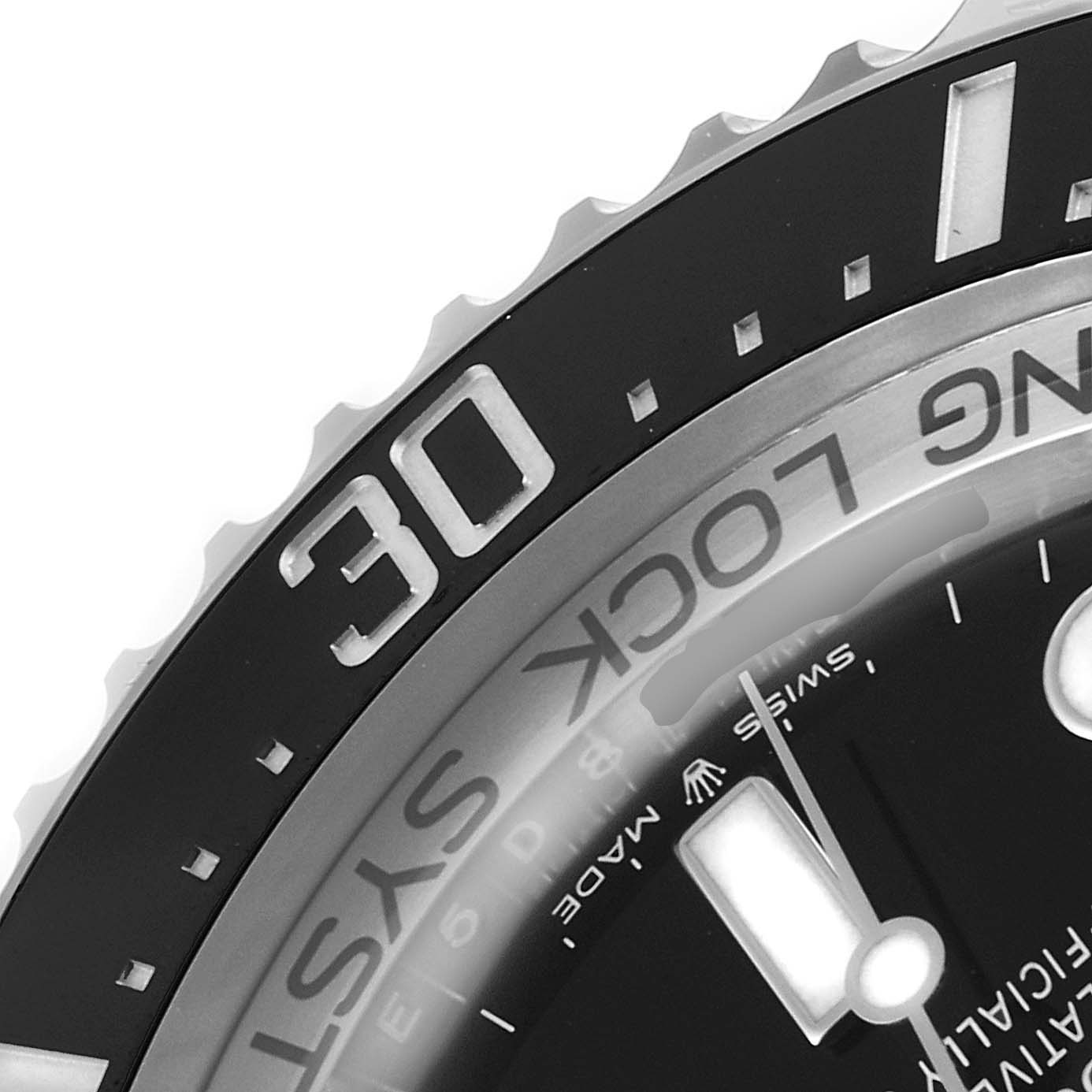 This close-up image of the Rolex Sea-Dweller 126660 Men
s Stainless Steel Black Dial 126660 Men
s Stainless Steel Black Dial watch shows a portion of the bezel, minute markers, and part of the dial.