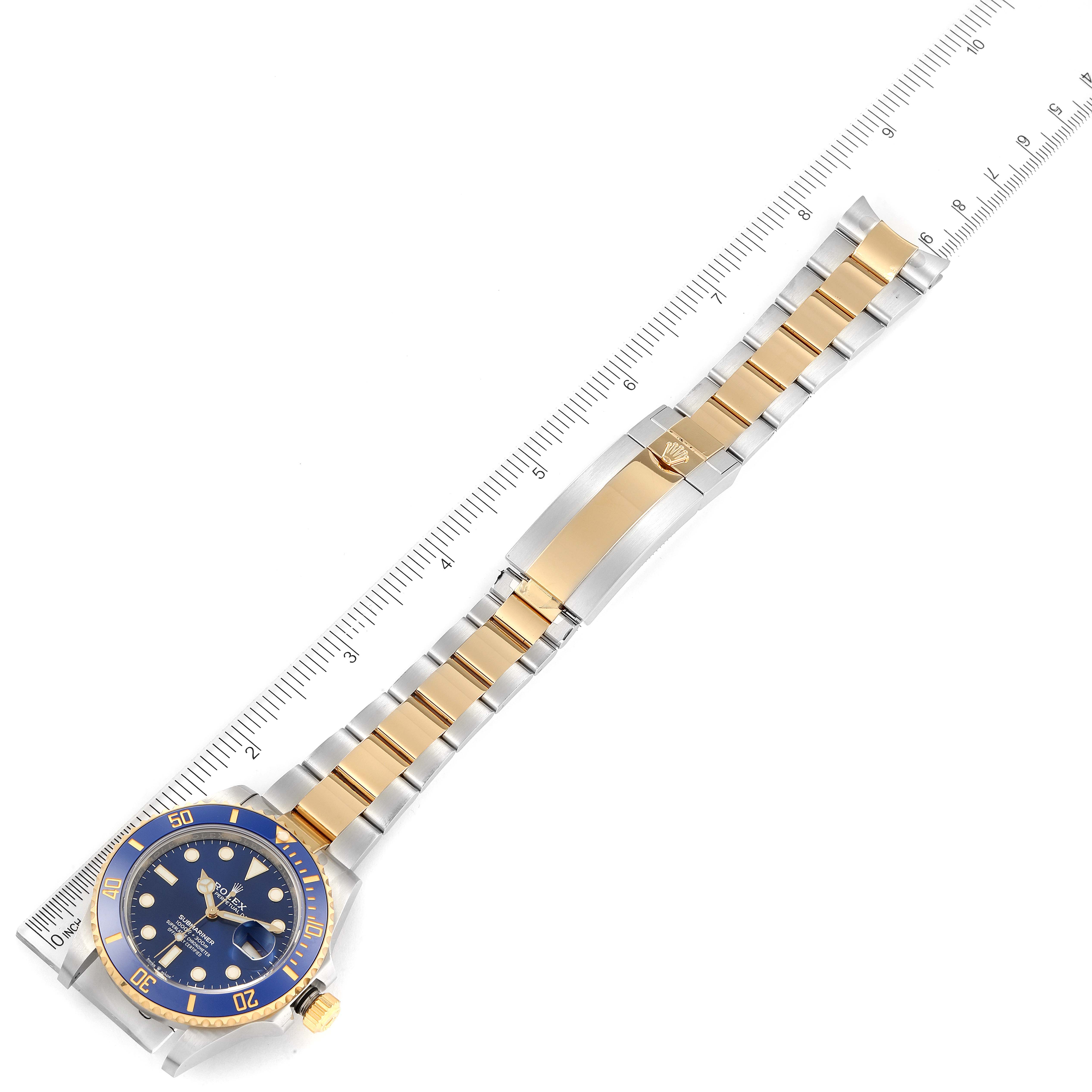 This image shows a top-down view of a Rolex Submariner 126613 Men
s Steel and Gold (two tone) Blue Dial 126613 Men
s Steel and Gold (two tone) Blue Dial, focusing on its blue dial, bezel, and two-tone metal bracelet.