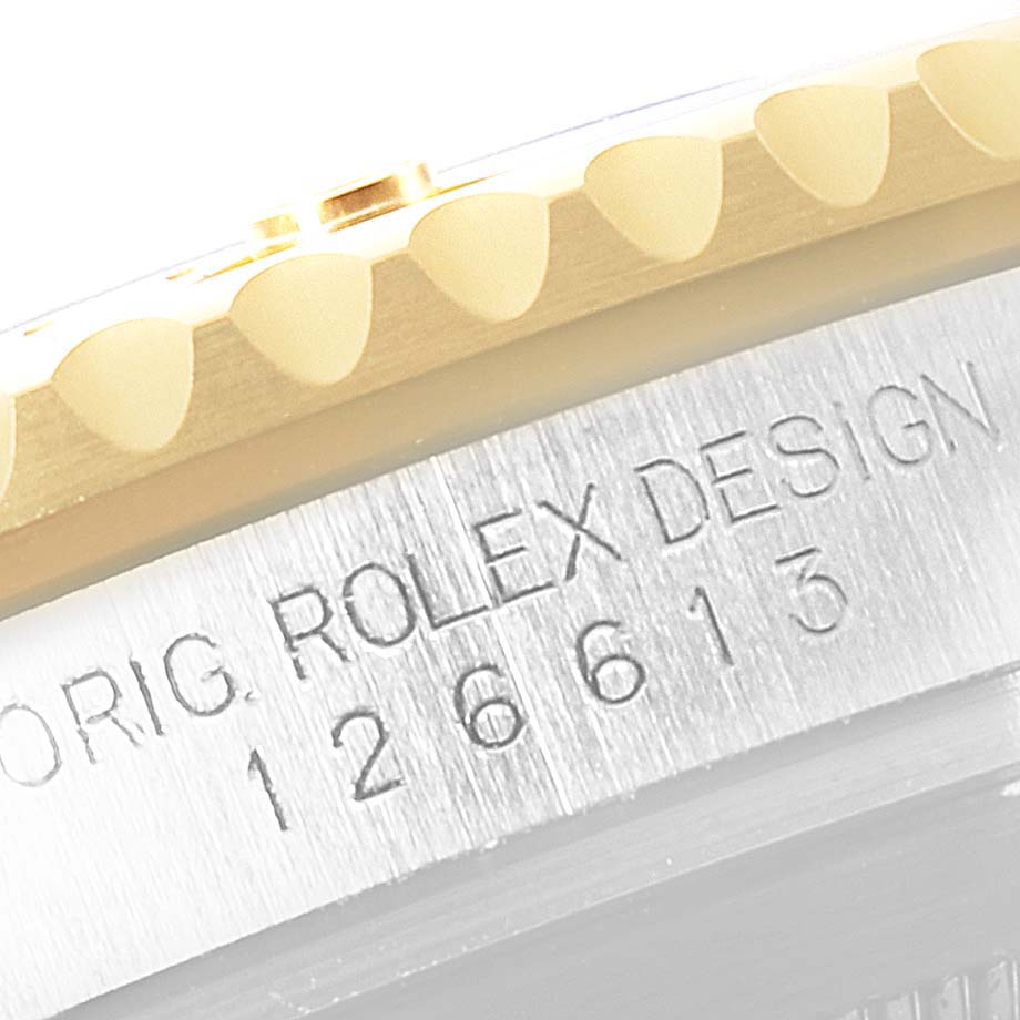 The image shows a close-up of the model number engraved on the side of a Rolex Submariner 126613 Men
s Steel and Gold (two tone) Blue Dial 126613 Men
s Steel and Gold (two tone) Blue Dial watch, near the bezel.