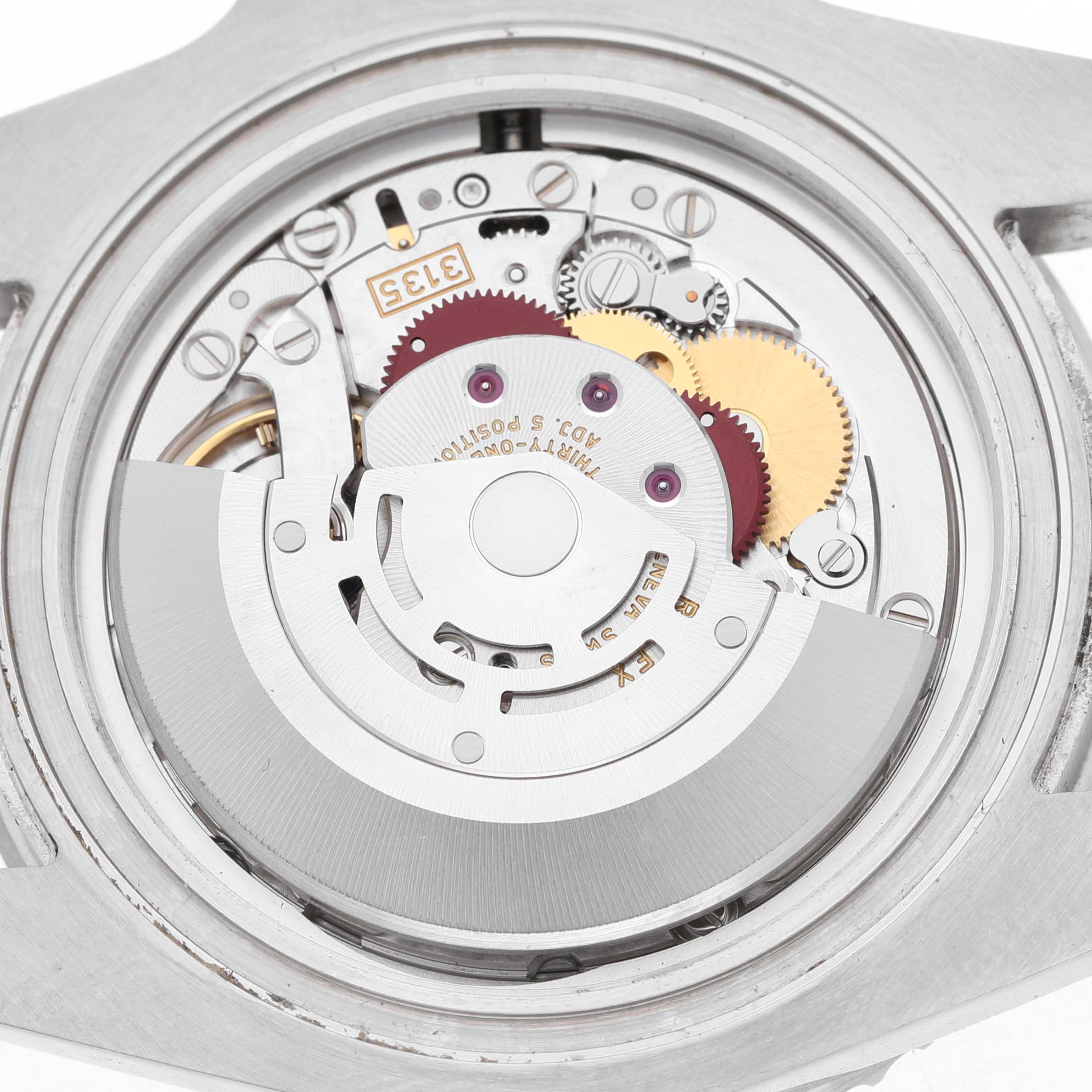 The image shows the movement of the Rolex Submariner 116610 Men's Stainless Steel Black Dial watch from a top-down angle, displaying gears and components.