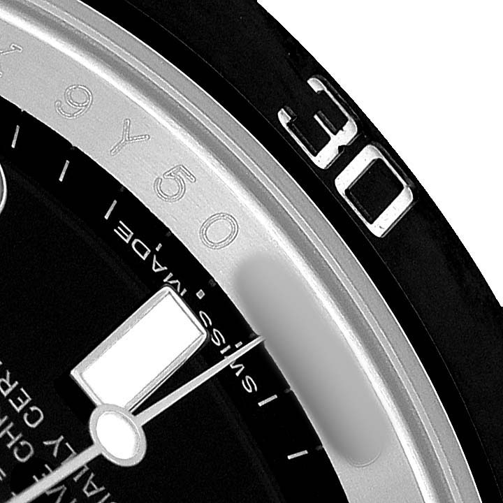 The image shows a close-up of a Rolex Submariner 116610 Men's Stainless Steel Black Dial, focusing on the bezel, part of the dial, and the minute hand.