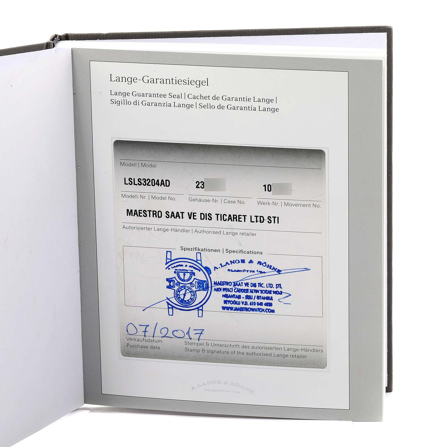 The image shows an open warranty card booklet for the Lange 1 model by A. Lange & Söhne, including dealer details and date of purchase.