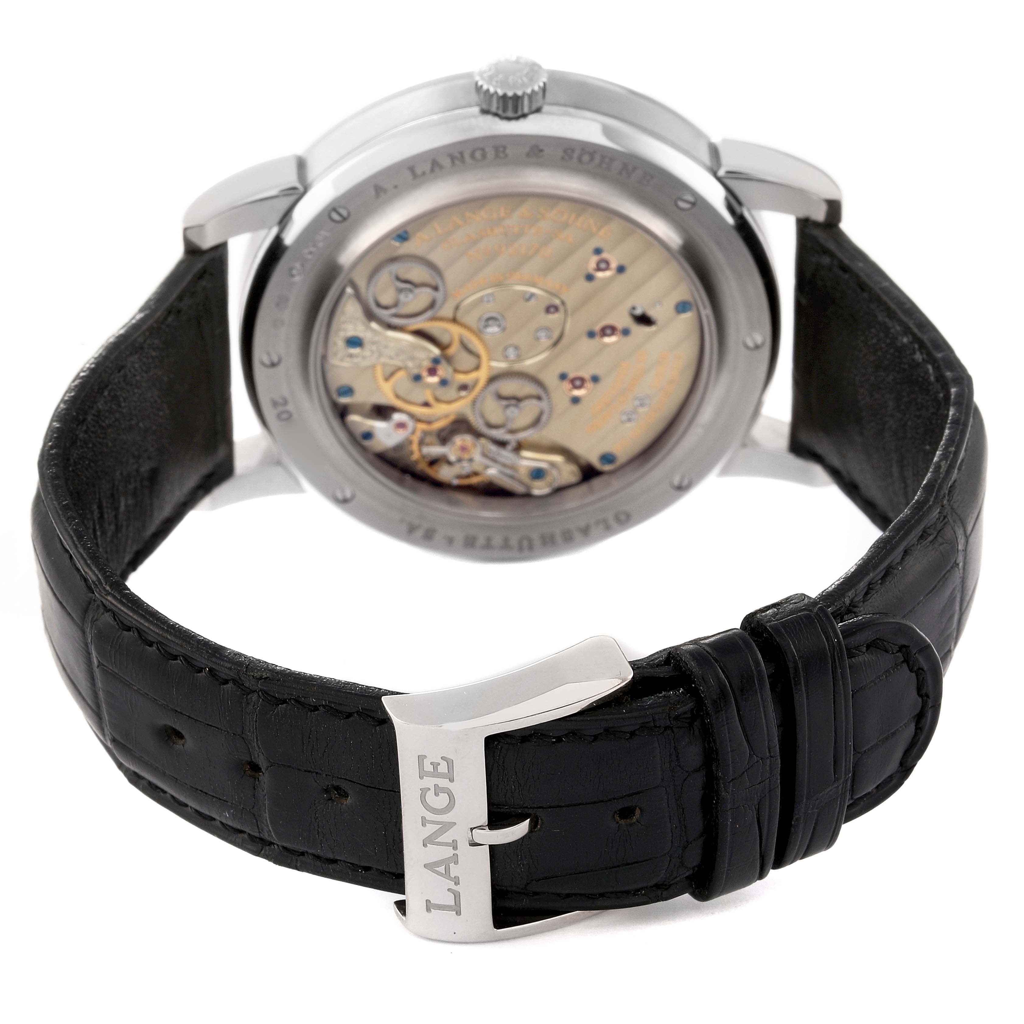 This image shows the back view of the A. Lange & Sohne Lange 1 116.039 Men's White Gold Silver Dial watch, highlighting its intricate movement and black leather strap with a "LANGE" engraved buckle.
