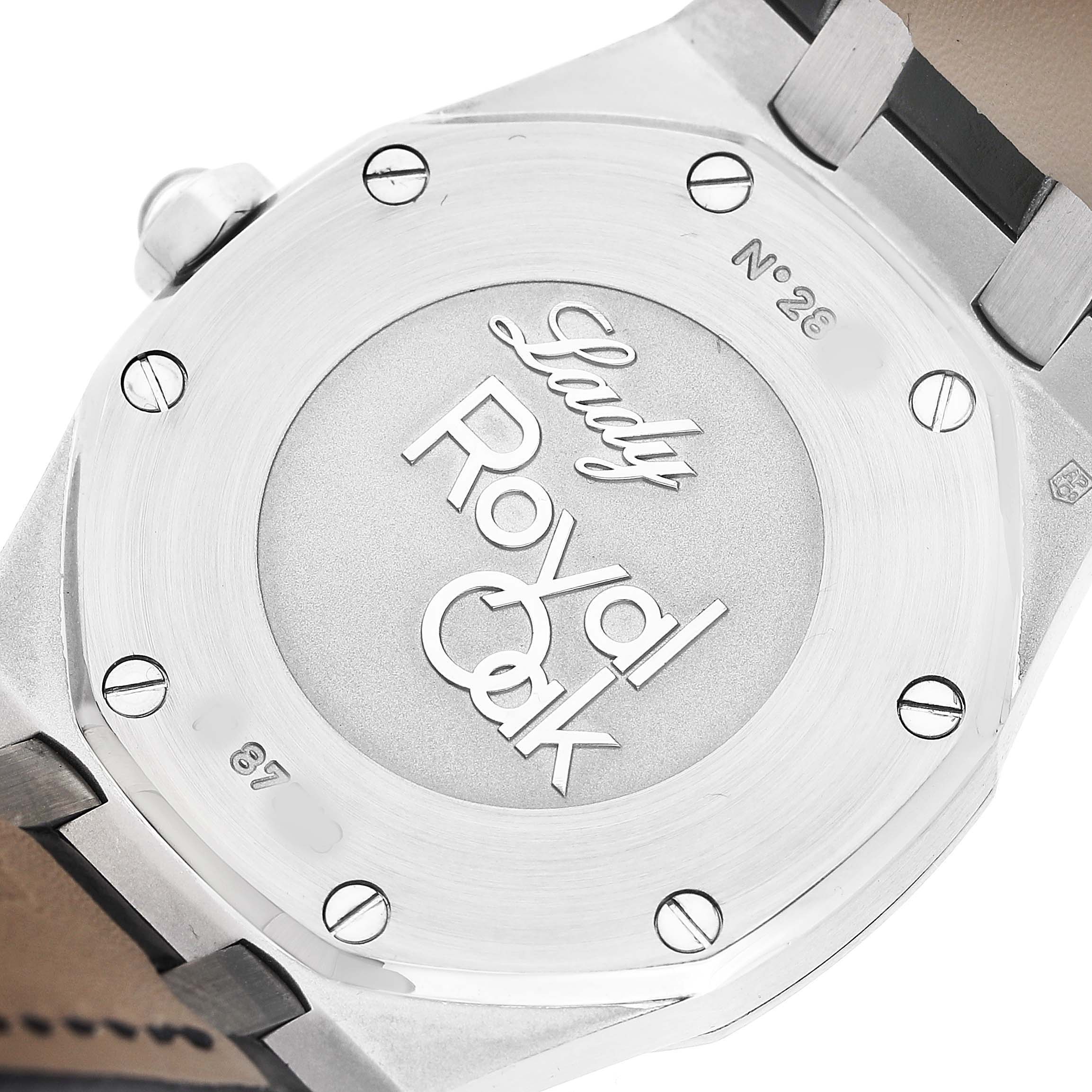 The photo shows the case back of an Audemars Piguet Royal Oak 67601ST.ZZ.D002CR.01 Women's Stainless Steel Black Dial Lady, highlighting the engravings and screws.