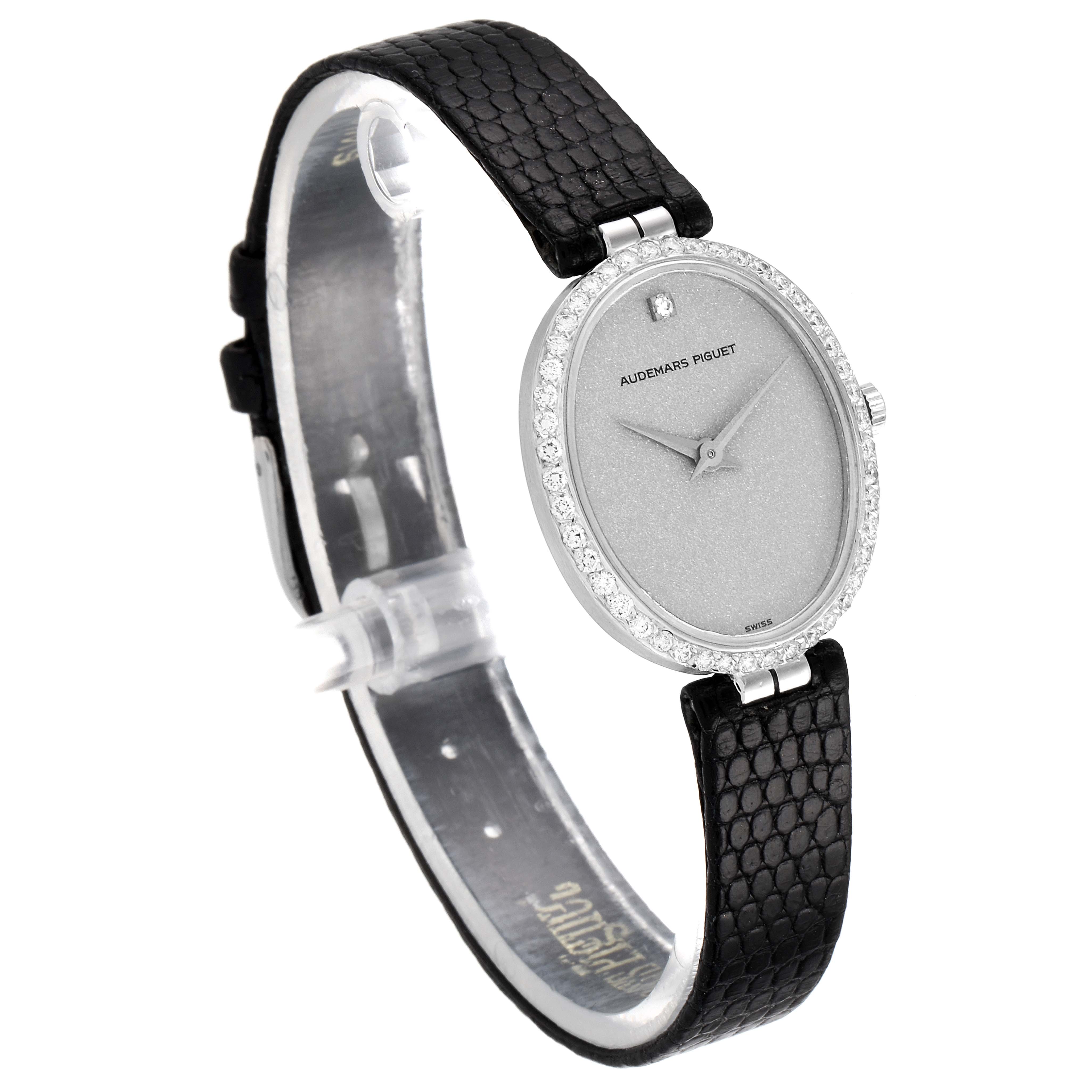 This image shows a side angle of the Audemars Piguet Vintage 7073BC Women's White Gold Silver Dial 7073BC Women's White Gold Silver Dial watch, highlighting its face, bezel, and leather strap.