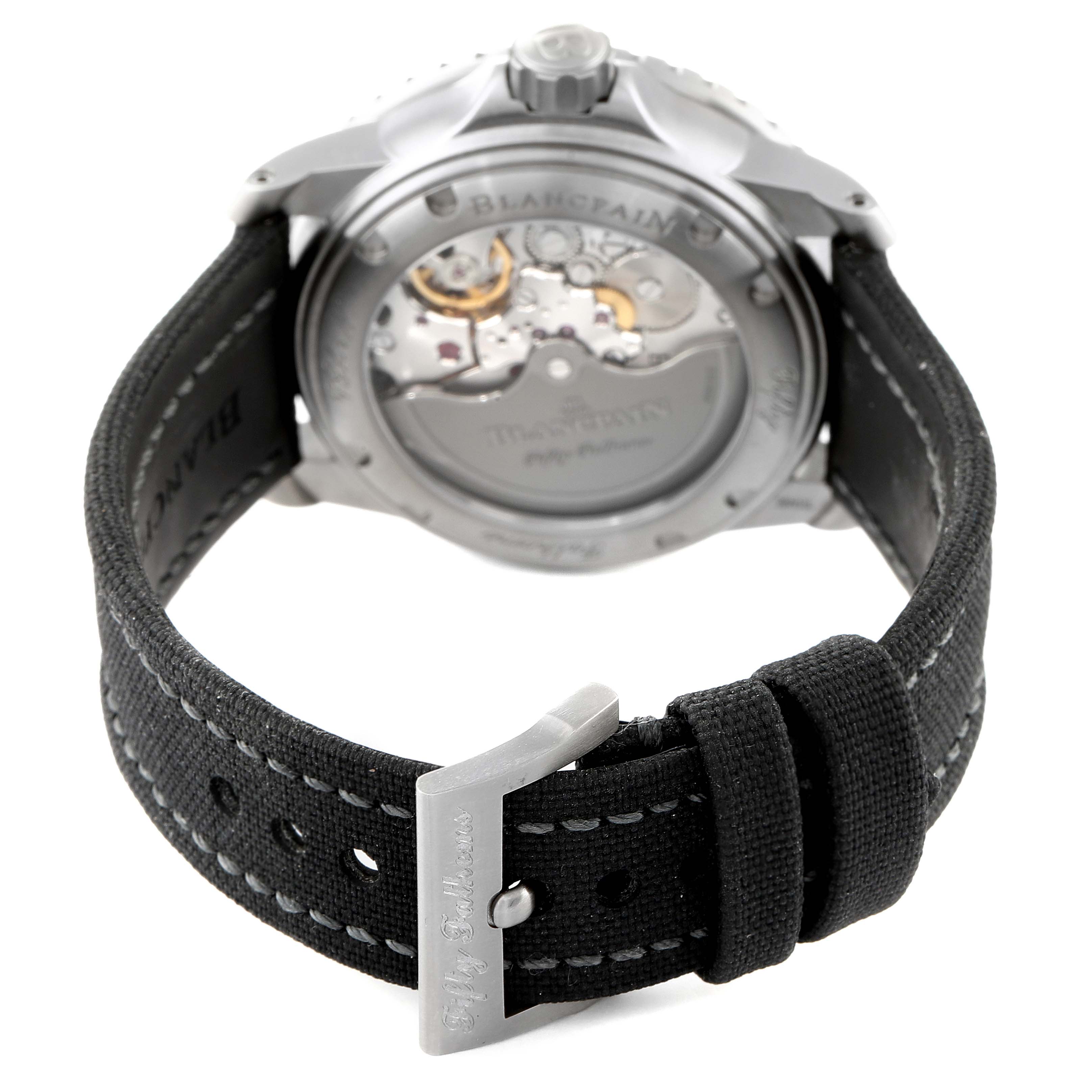 The image shows the back view of the Fifty Fathoms watch by Blancpain, displaying the movement and the strap's buckle.