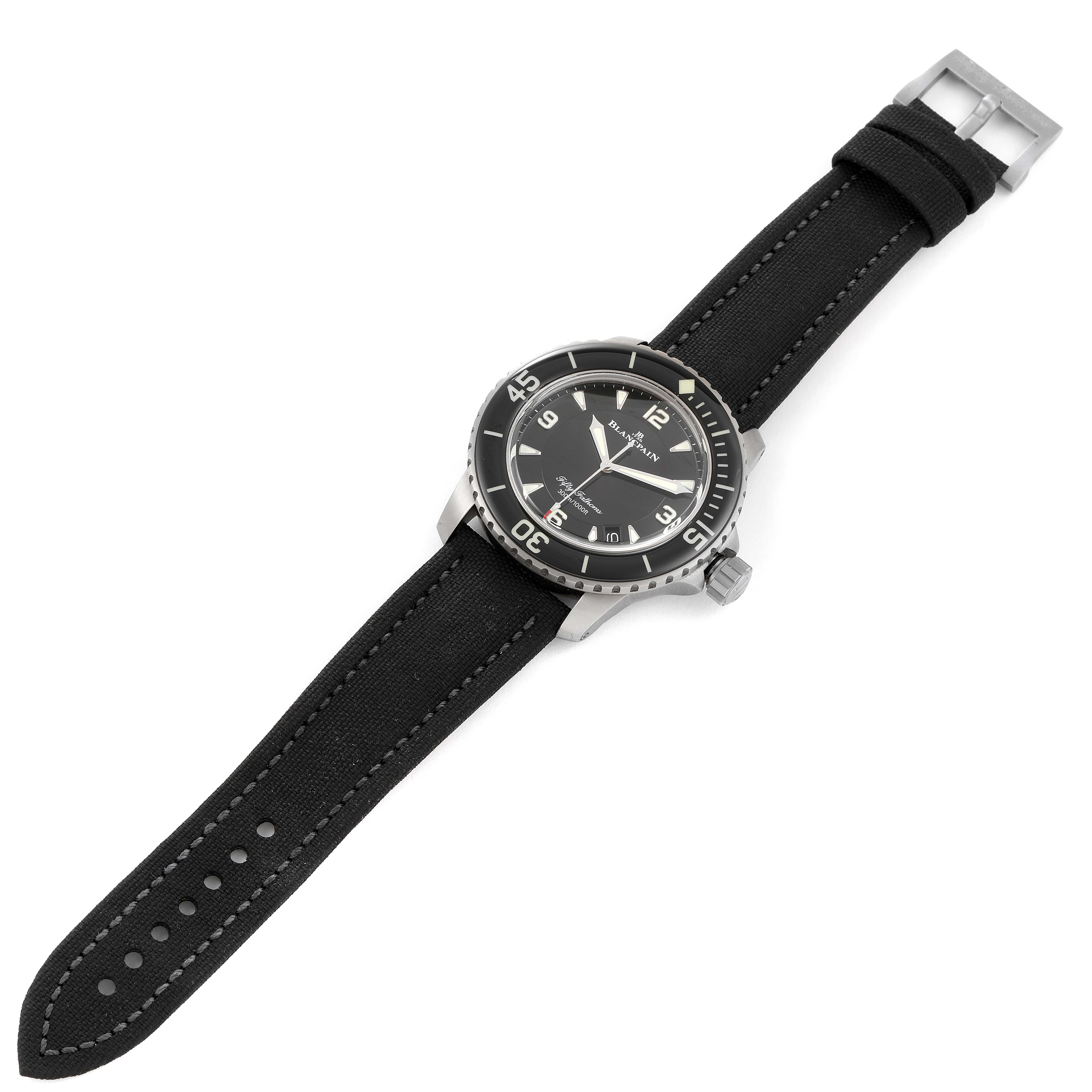 The Blancpain Fifty Fathoms 5015-1130-52A Men's Titanium Black Dial 5015-1130-52A Men's Titanium Black Dial watch is shown from a top-down angle, displaying the face, bezel, crown, and black strap.