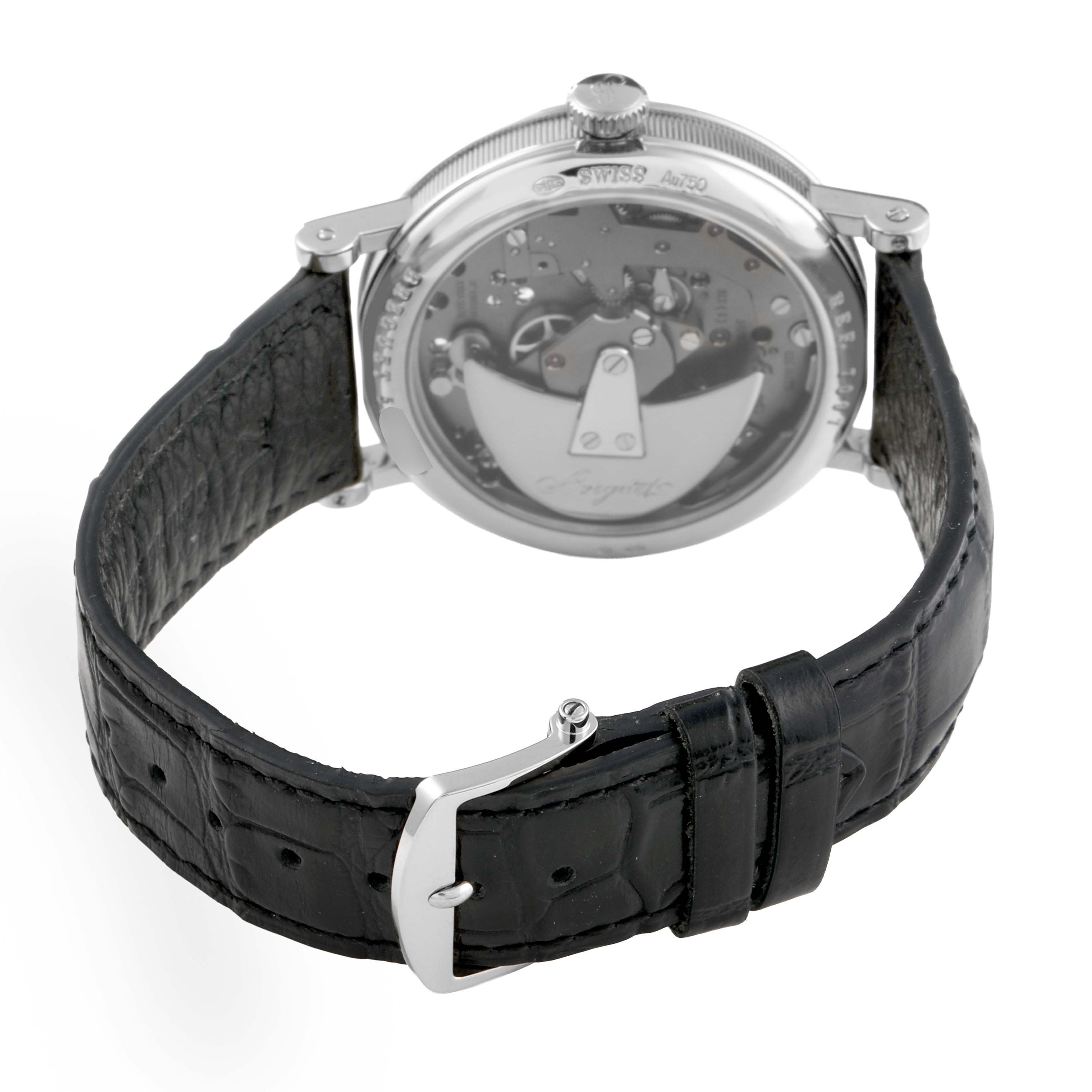 The image shows the back view of a Breguet Tradition 7097 Men's White Gold Silver Dial watch, highlighting the movement and black leather strap with a buckle.