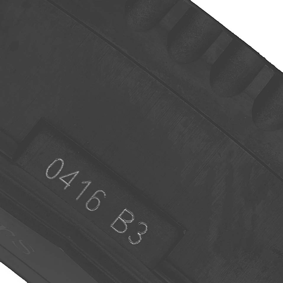 The image shows a close-up of the band or strap of a Breitling Navitimer MB012822 / BE51 Men's Stainless Steel Black Dial watch with visible engraved markings.