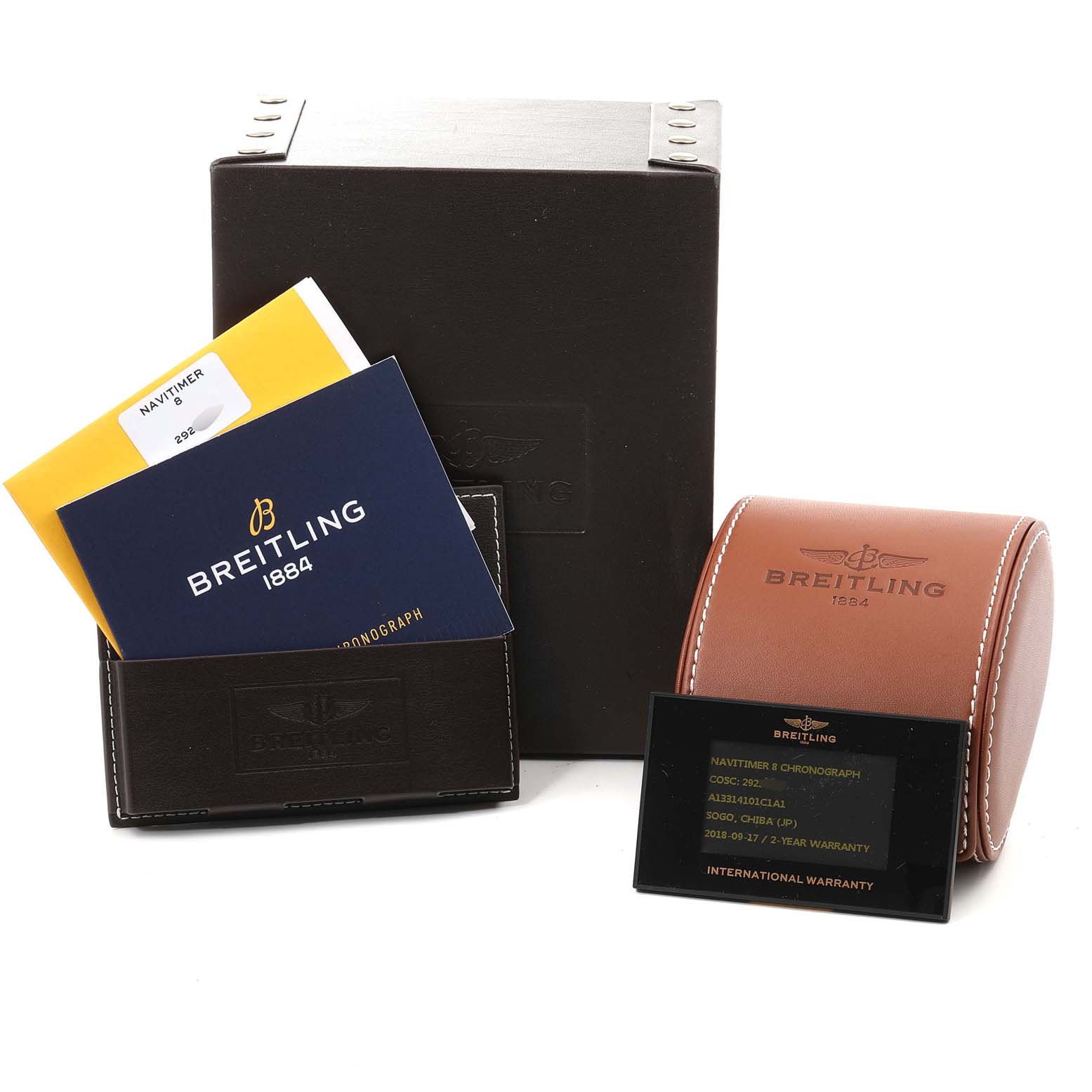 The image shows the Breitling Navitimer A1331410/C997/189A Men
s Stainless Steel Blue Dial A1331410/C997/189A Men
s Stainless Steel Blue Dial watch box, instruction manuals, a warranty card, and a leather watch case.