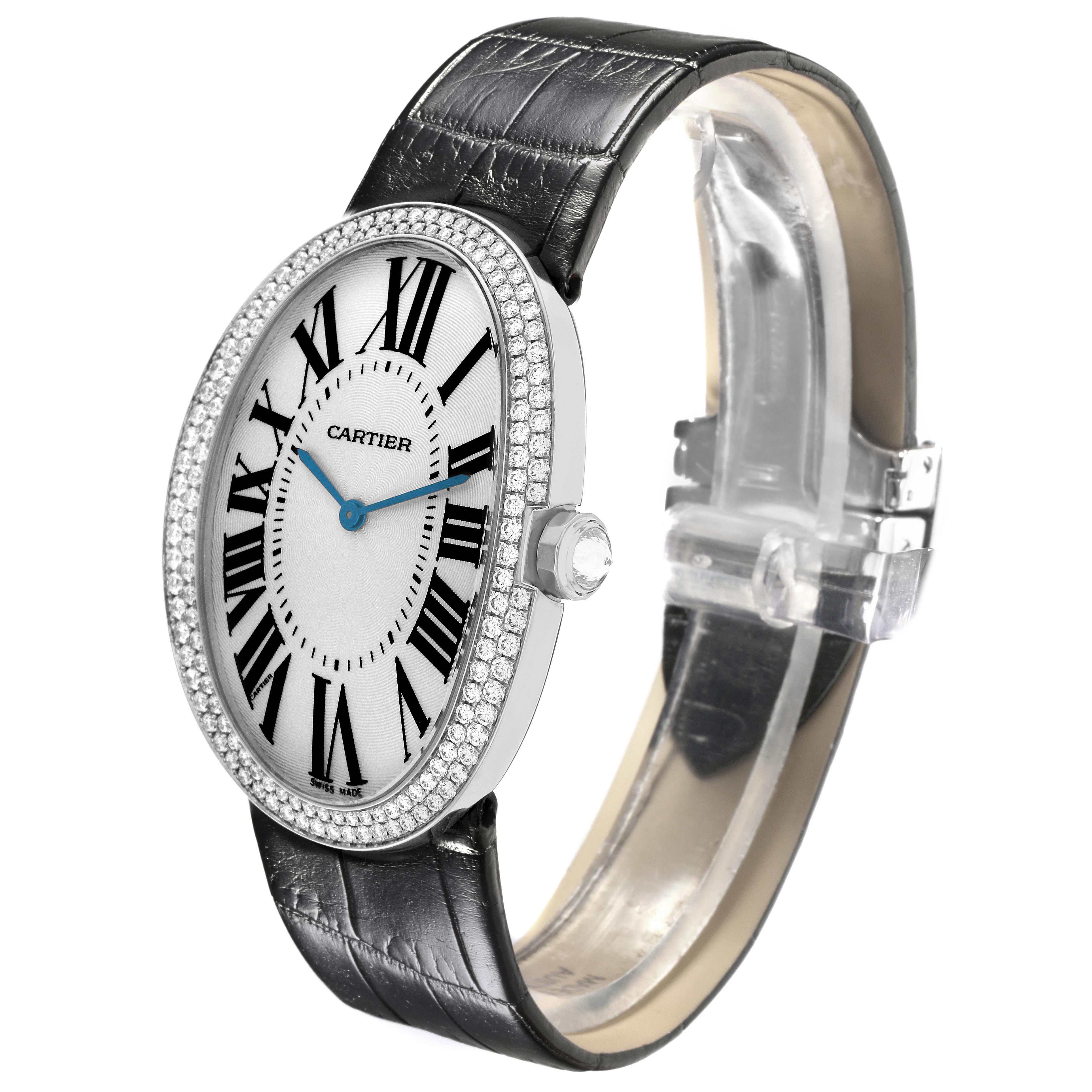 The Cartier Baignoire WB520009 Women
s White Gold Silver Dial WB520009 Women
s White Gold Silver Dial watch is shown at a side angle, highlighting its oval face, diamond bezel, Roman numerals, and leather strap.