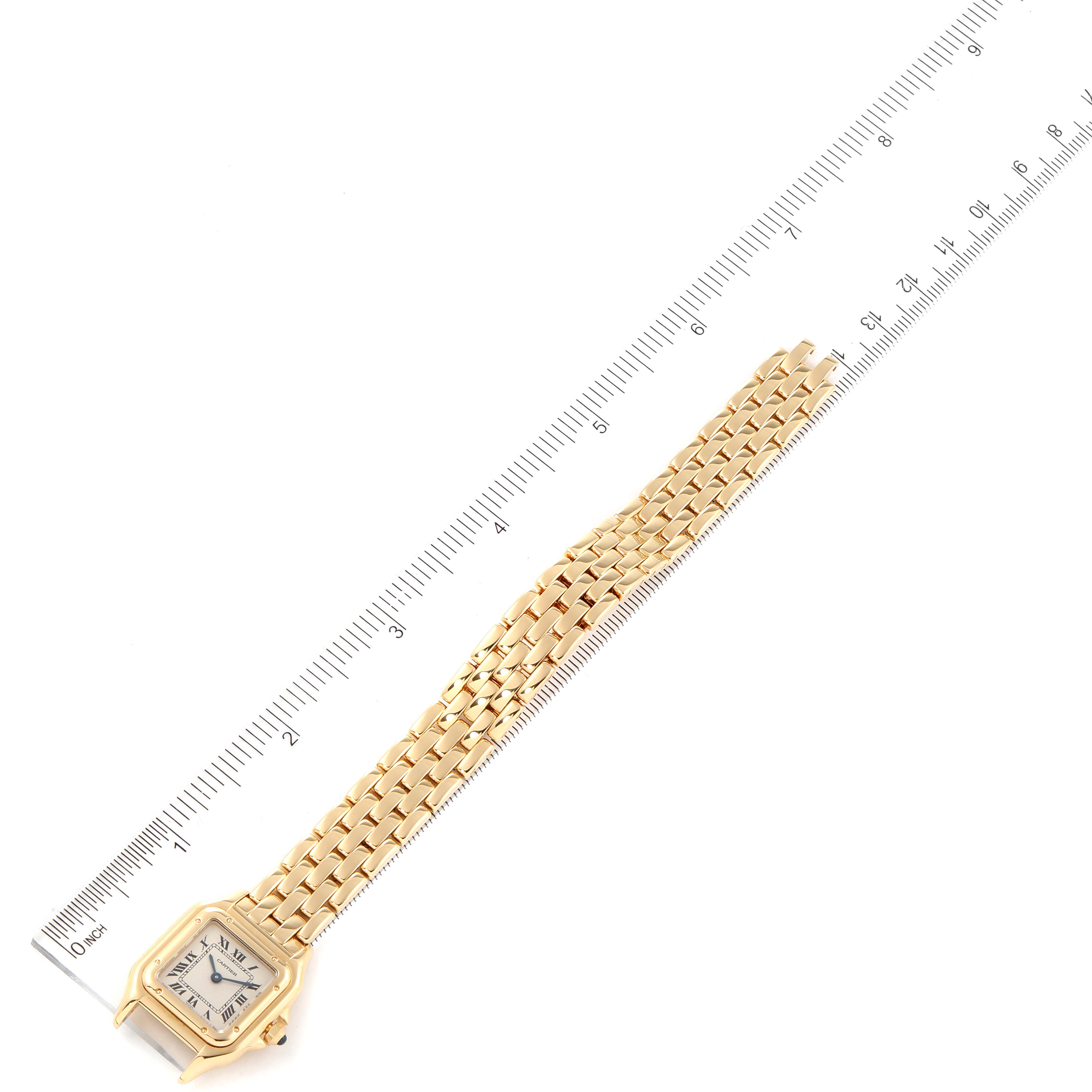 The image shows a Cartier Panthere W25022B9 Women's Yellow Gold Silver Dial W25022B9 Women's Yellow Gold Silver Dial model watch laid flat next to a ruler, displaying the face and bracelet.