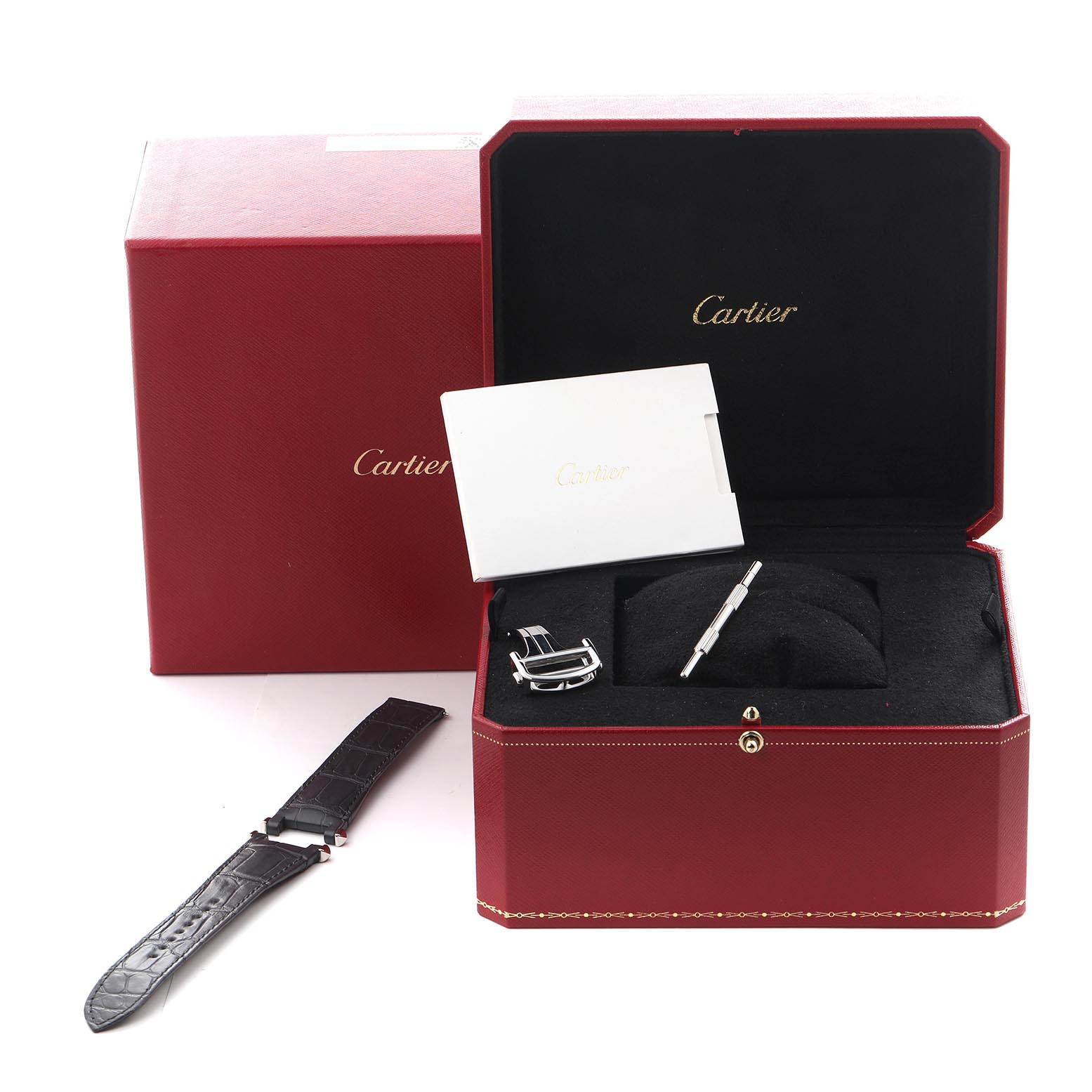 The image shows a Cartier Pasha WSPA0018 Men's Stainless Steel Silver Dial WSPA0018 Men's Stainless Steel Silver Dial watch box with a strap, buckle, and tool, viewed from above.