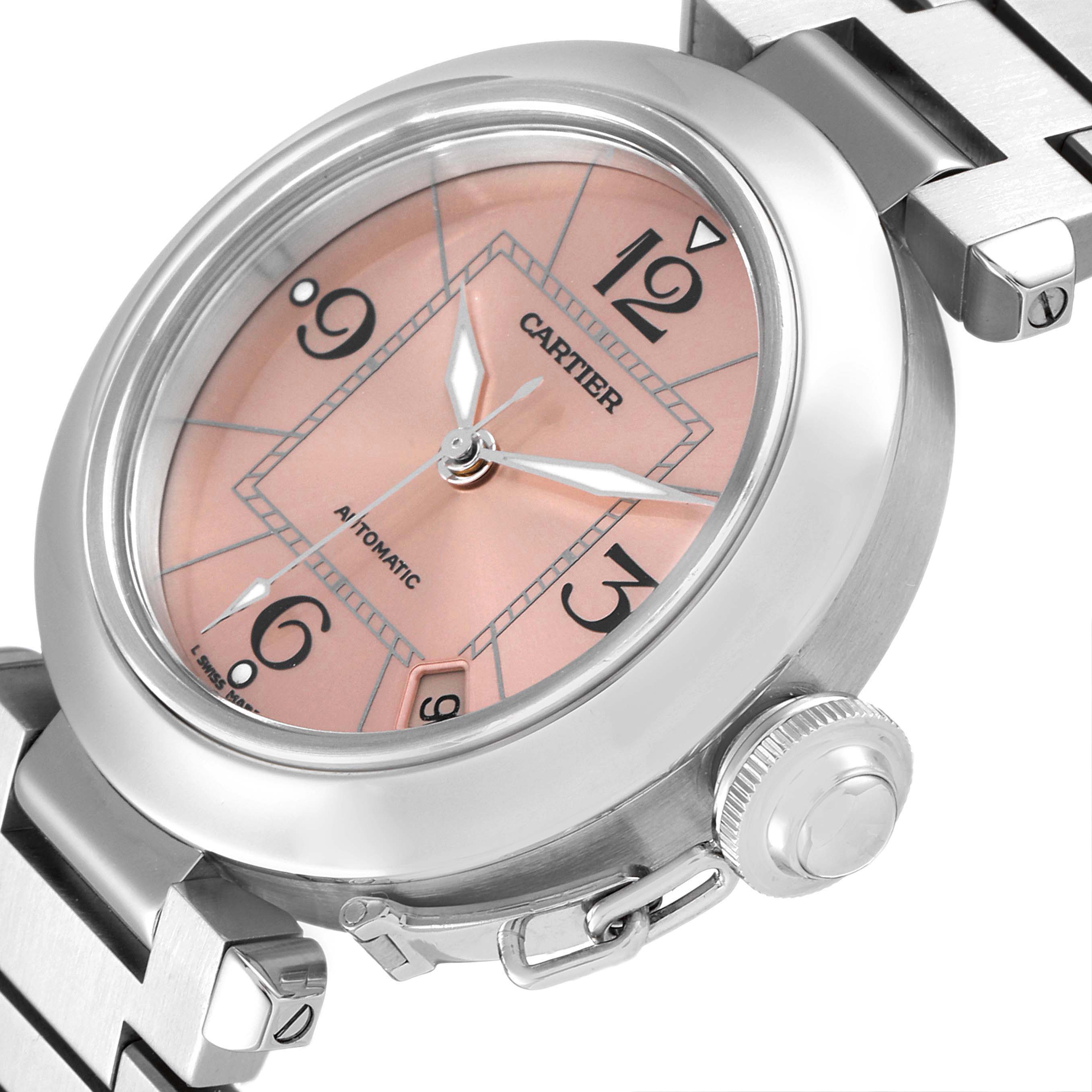 The image shows a Cartier Pasha W31075M7 Women's Stainless Steel Pink Dial W31075M7 Women's Stainless Steel Pink Dial watch at an angle, highlighting the pink dial, crown, and part of the stainless steel bracelet.