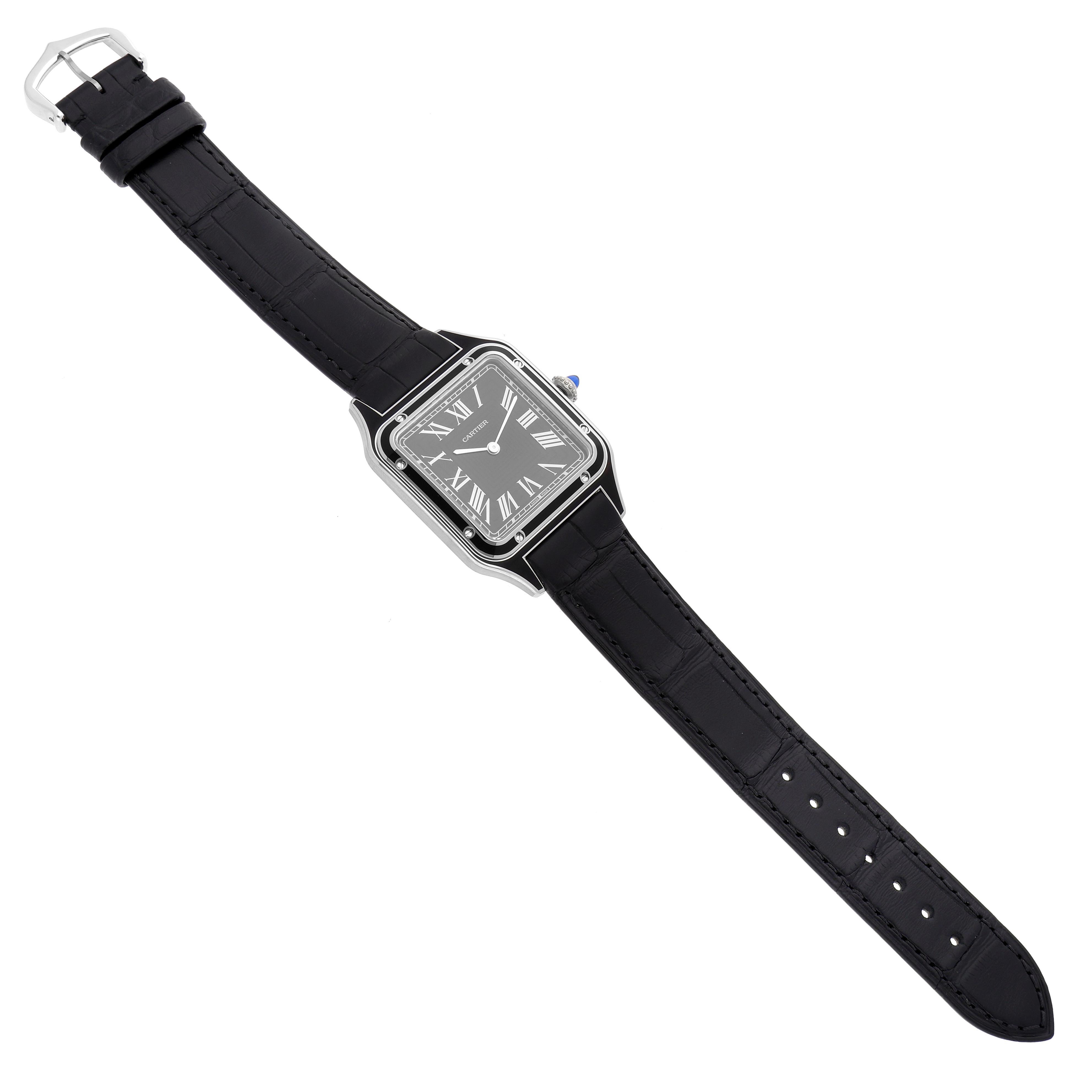 The Cartier Santos Dumont WSSA0046 Men's Stainless Steel Black Dial WSSA0046 Men's Stainless Steel Black Dial watch is shown from a top-down angle, displaying its black dial, Roman numerals, and black strap.
