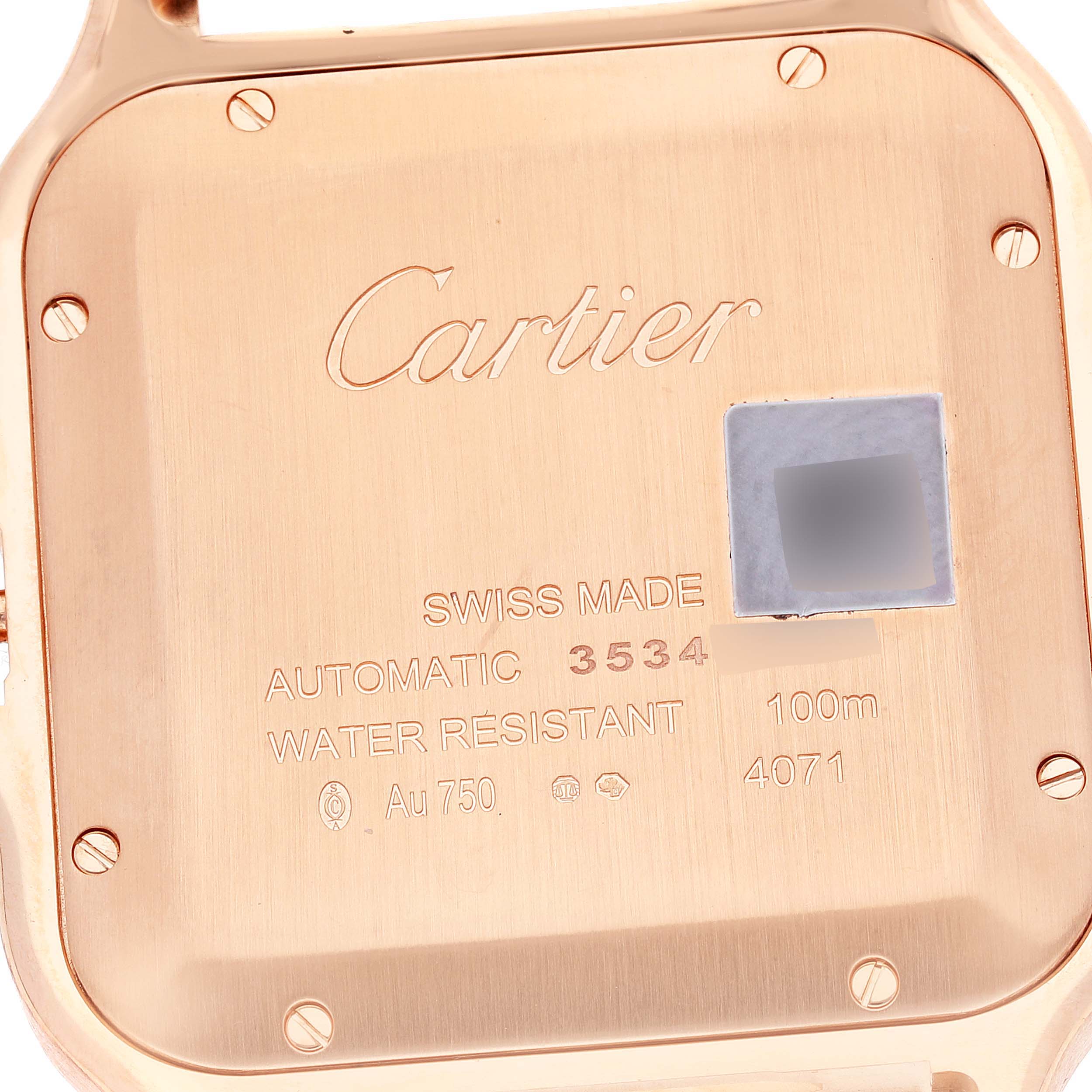 The image shows the case back of a Cartier Santos WGSA0019 Men's Rose Gold Silver Dial WGSA0019 Men's Rose Gold Silver Dial watch, featuring engraved details about the model.