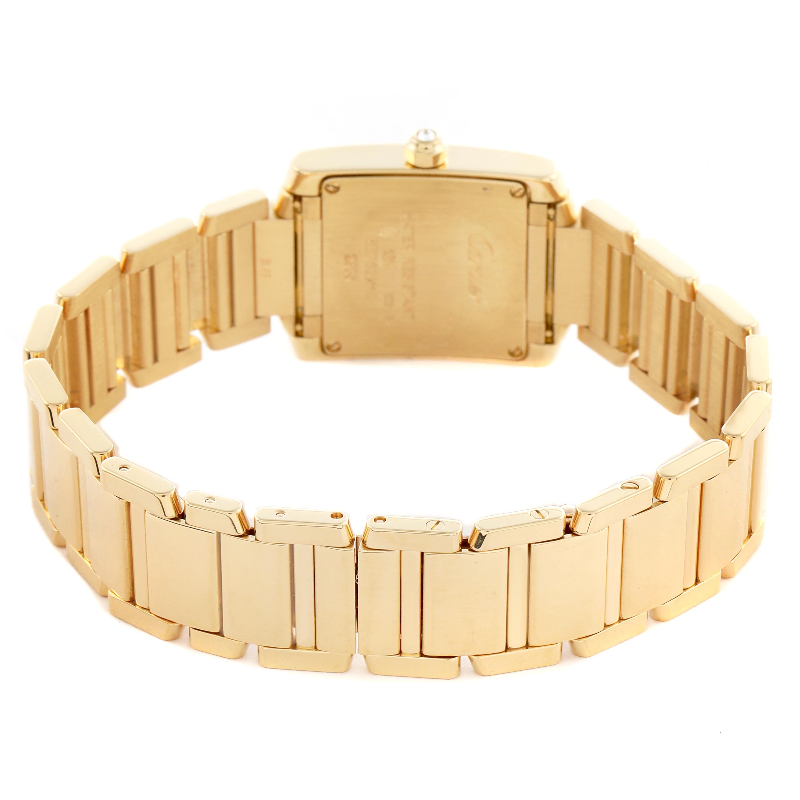 The image shows the back of the Cartier Tank Française watch, highlighting the gold bracelet and case back from a rear angle.