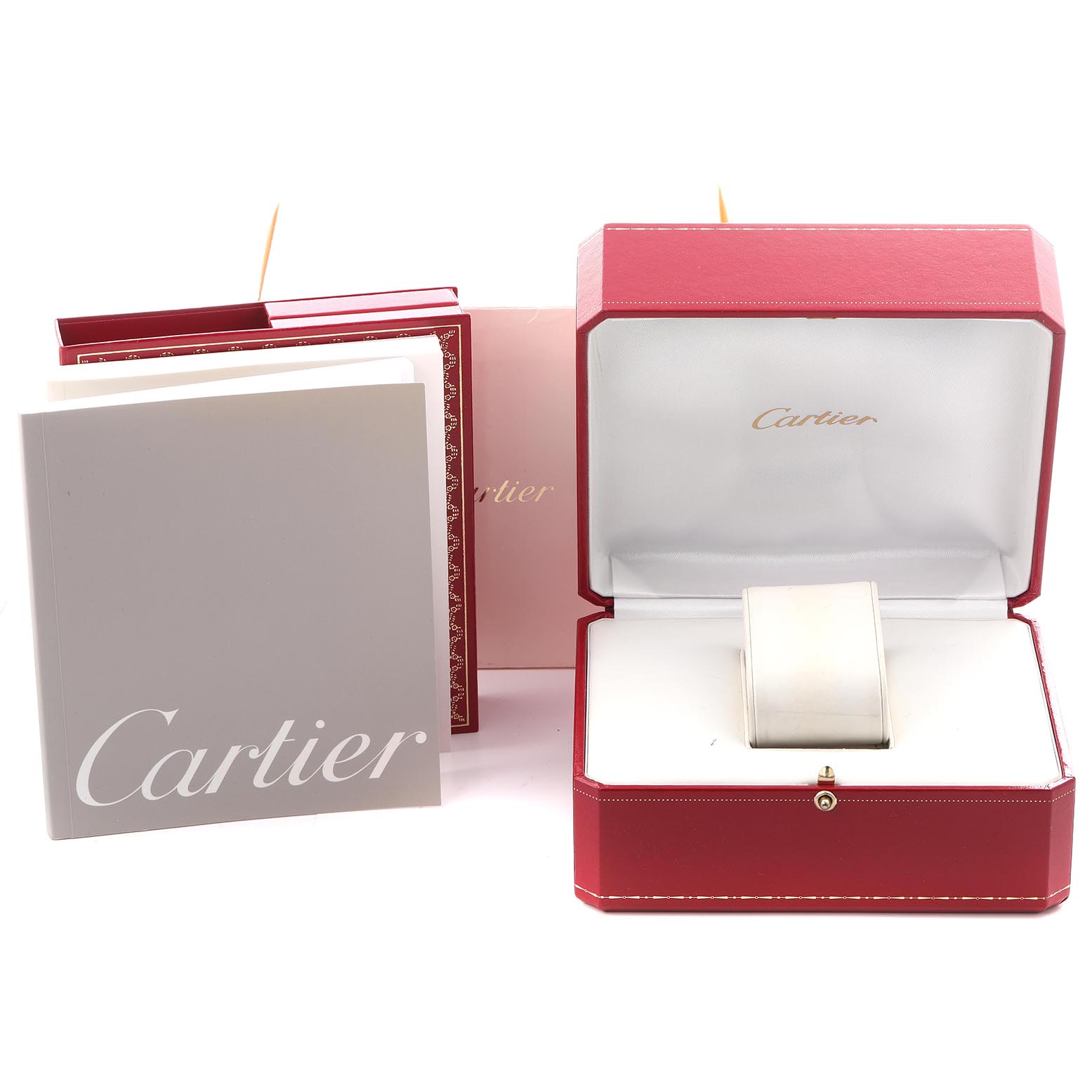 The image shows a Cartier Tank Française watch box, open and empty, with instruction booklets beside it.