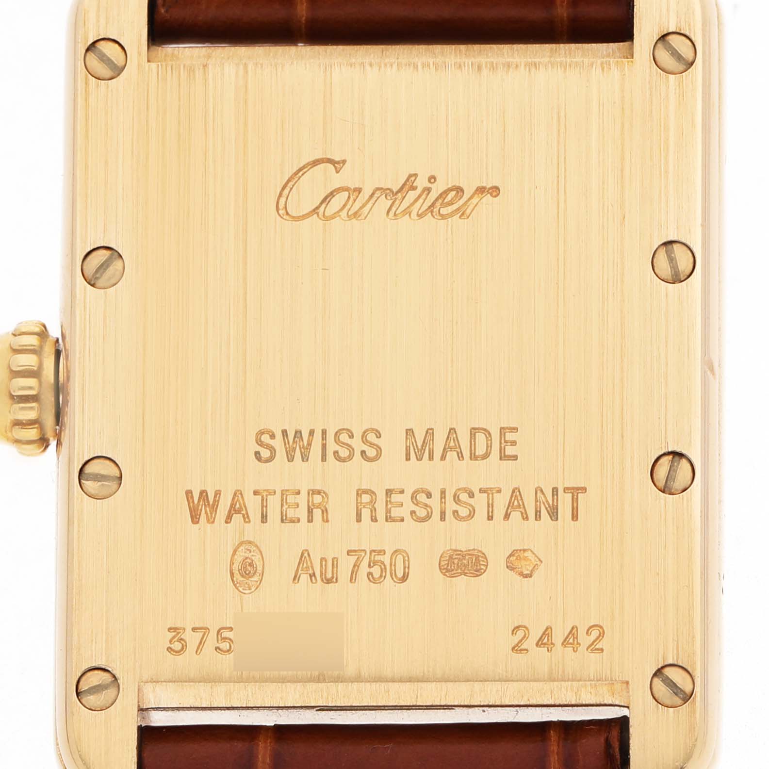 The image shows the back of a Cartier Tank Louis W1529856 Women's Yellow Gold Silver Dial watch, highlighting its engraving and the leather strap attachment.