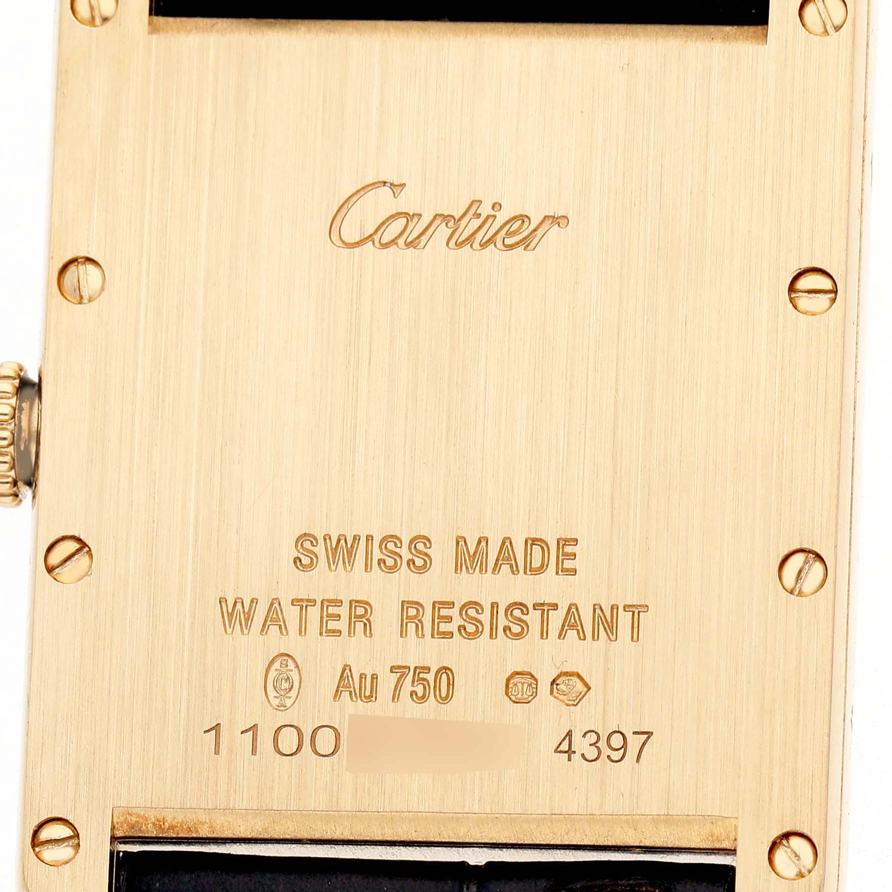 The image shows the back of a Cartier Tank Louis WGTA0067 Men's Yellow Gold Silver Dial watch case, highlighting the engravings and screws.