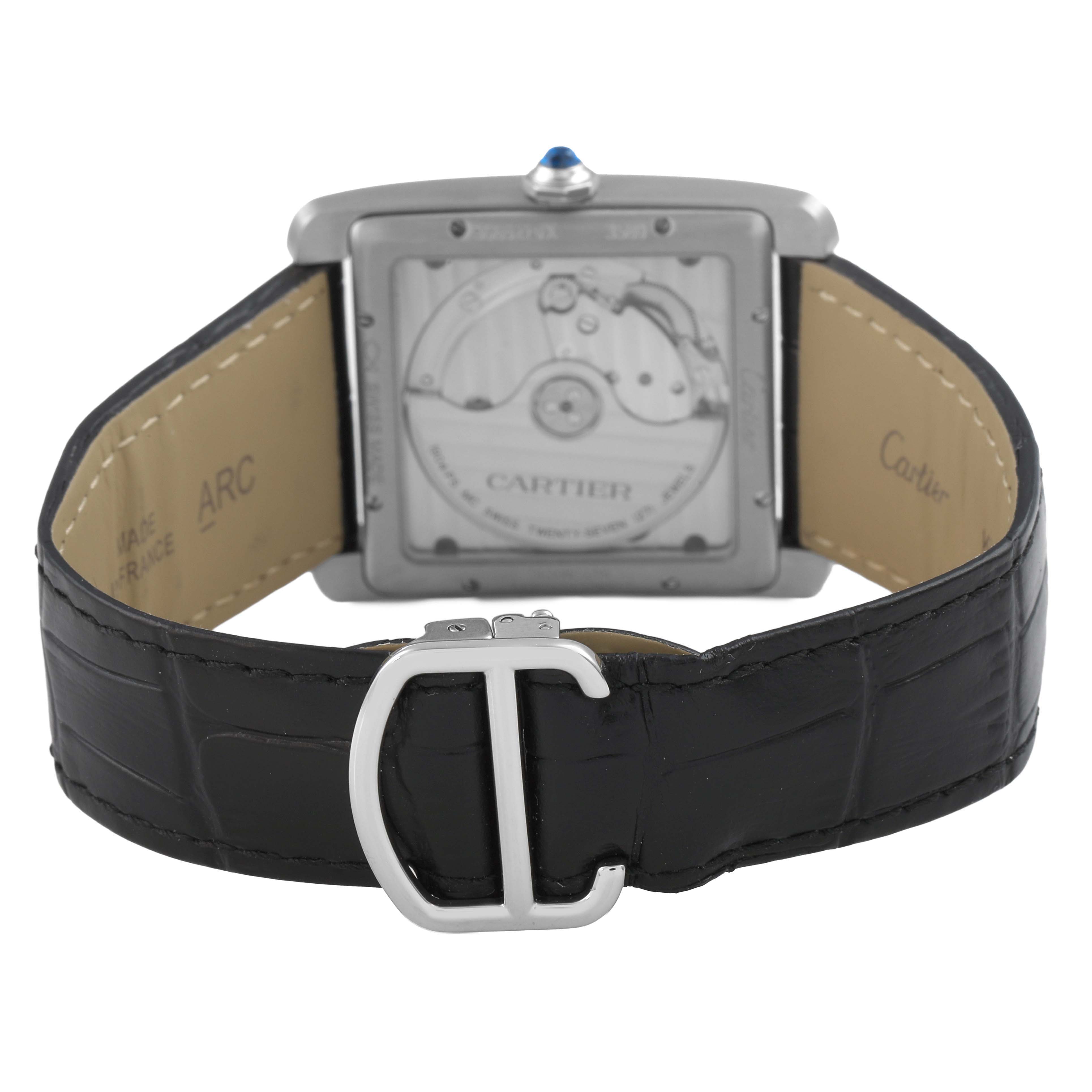 The image shows the back of the Cartier Tank MC WSTA0010 Men's Stainless Steel Blue Dial watch, highlighting the movement and leather strap with buckle.