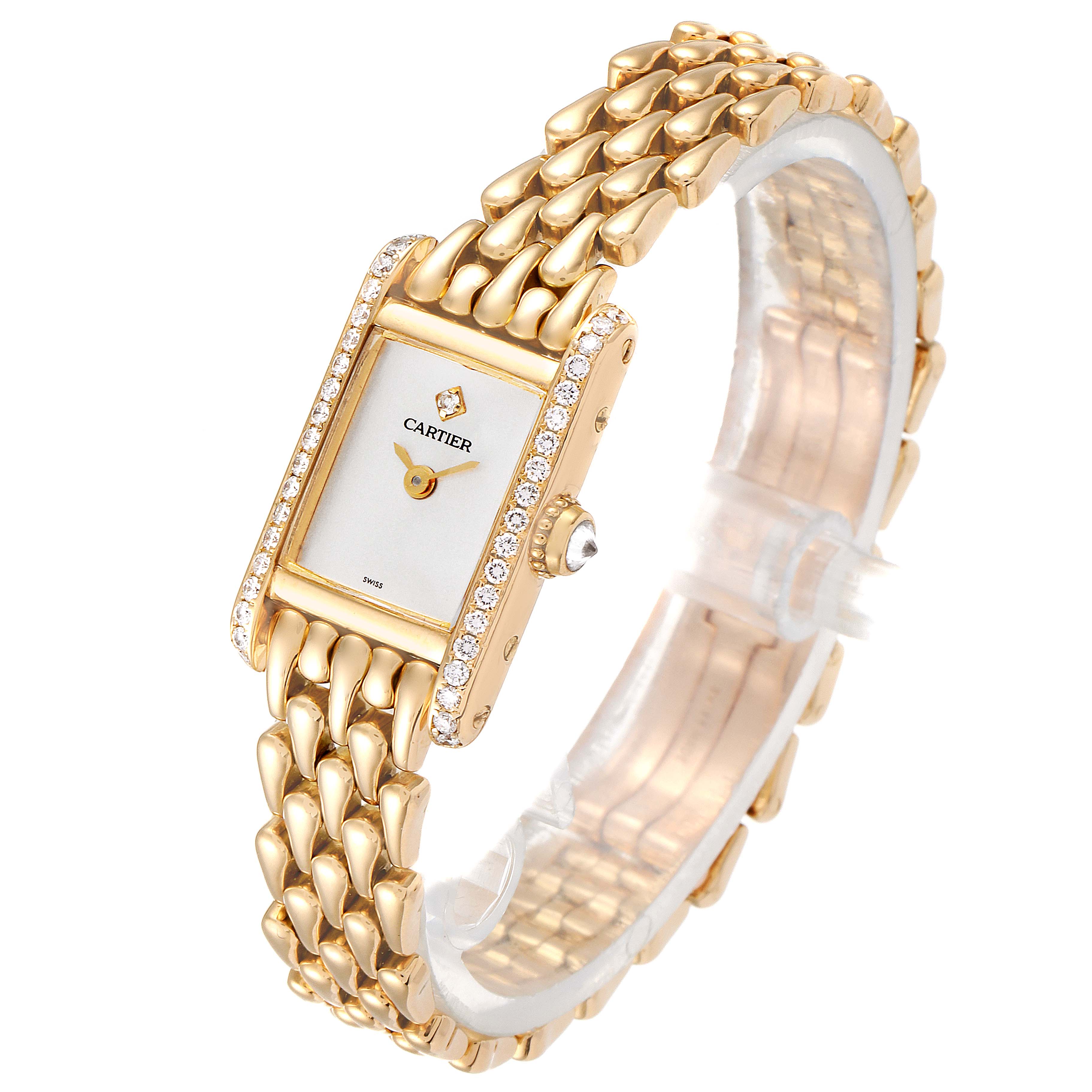 The image shows a gold Cartier Tank Louis 1360.1 Women's Yellow Gold Silver Dial 1360.1 Women's Yellow Gold Silver Dial watch at an angle, highlighting its face, diamond bezel, and linked bracelet.