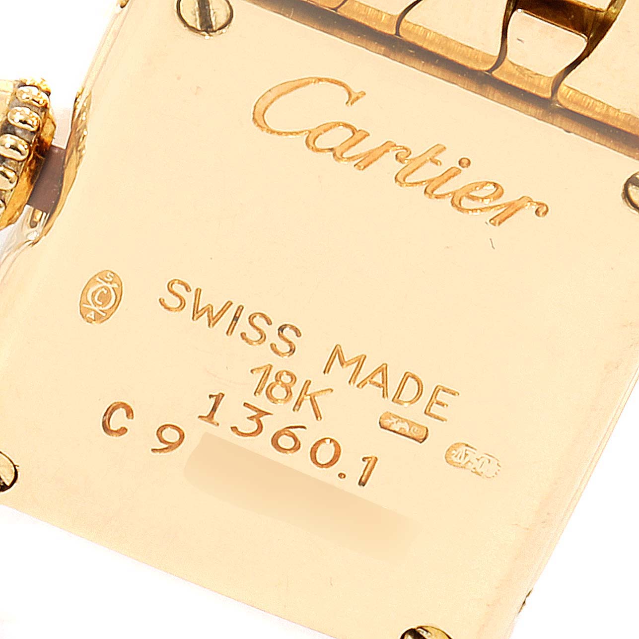 This image shows the back case of a Cartier Tank Louis 1360.1 Women's Yellow Gold Silver Dial 1360.1 Women's Yellow Gold Silver Dial watch, highlighting the brand name, materials, and model information.