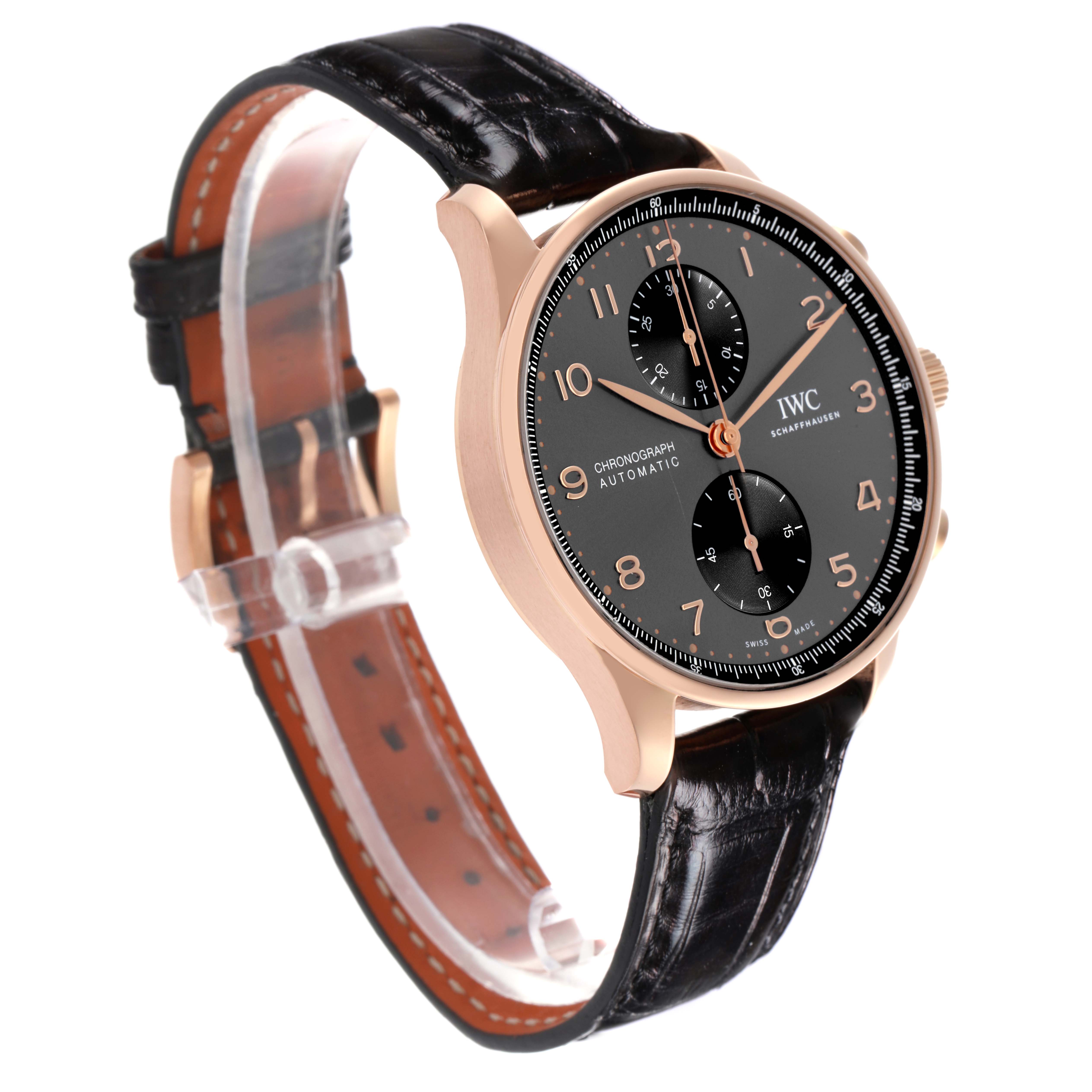 The IWC Portuguese IW371610 Men's Rose Gold Grey Dial IW371610 Men's Rose Gold Grey Dial watch is shown at a three-quarter angle highlighting the black dial, gold case, and leather strap.