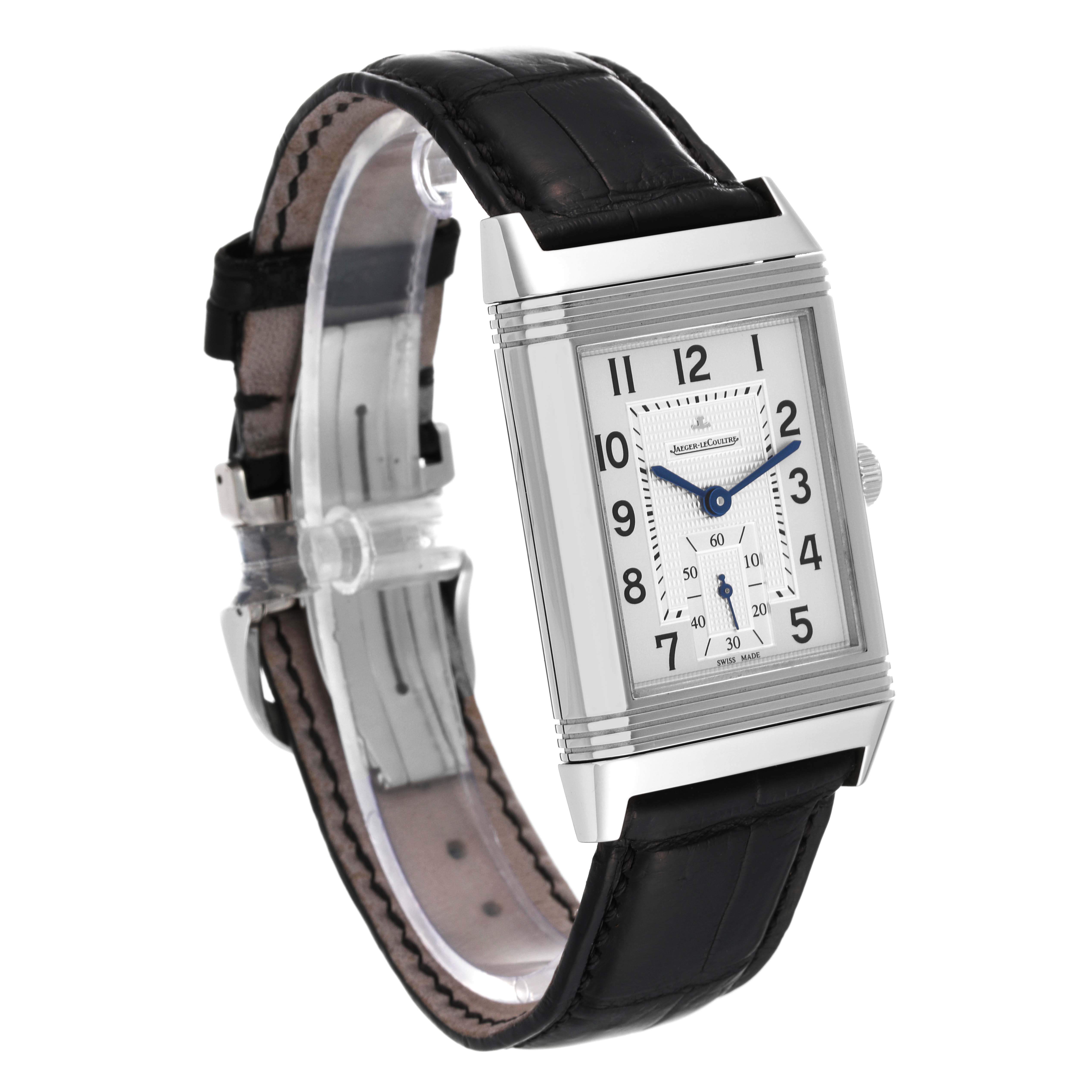 The image shows a Jaeger-LeCoultre Reverso watch, angled to display the face, dial, crown, leather strap, and buckle.