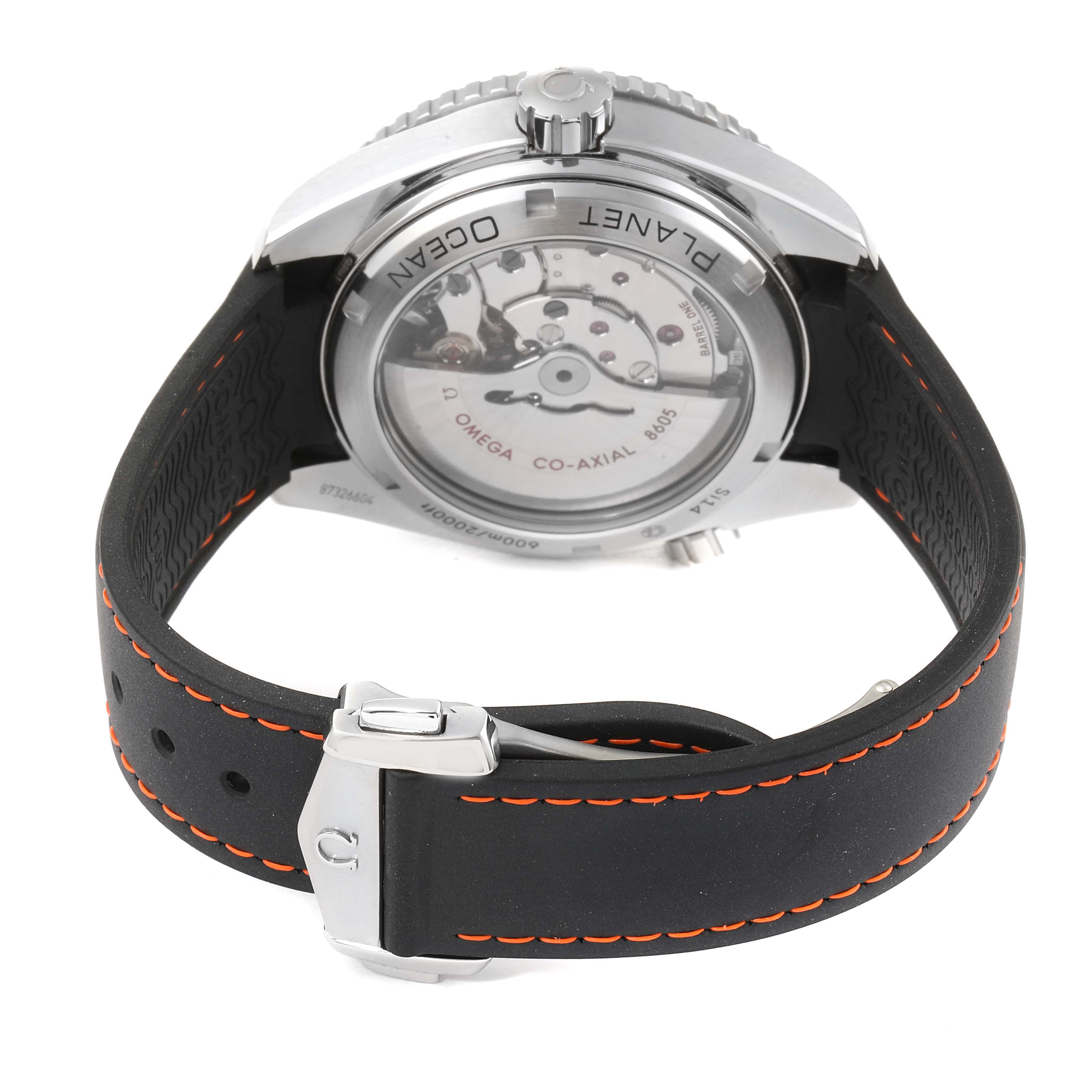 This image shows the back side of the Omega Planet Ocean 232.32.44.22.01.002 Men
s Stainless Steel Black Dial 232.32.44.22.01.002 Men
s Stainless Steel Black Dial watch, revealing the movement and strap with orange stitching.
