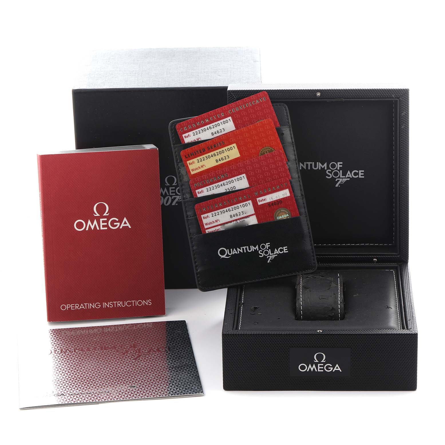 The image shows the packaging and accessories for the Omega Planet Ocean 222.30.46.20.01.001 Men's Stainless Steel Black Dial 222.30.46.20.01.001 Men's Stainless Steel Black Dial, including the box, cards, and instruction manual.