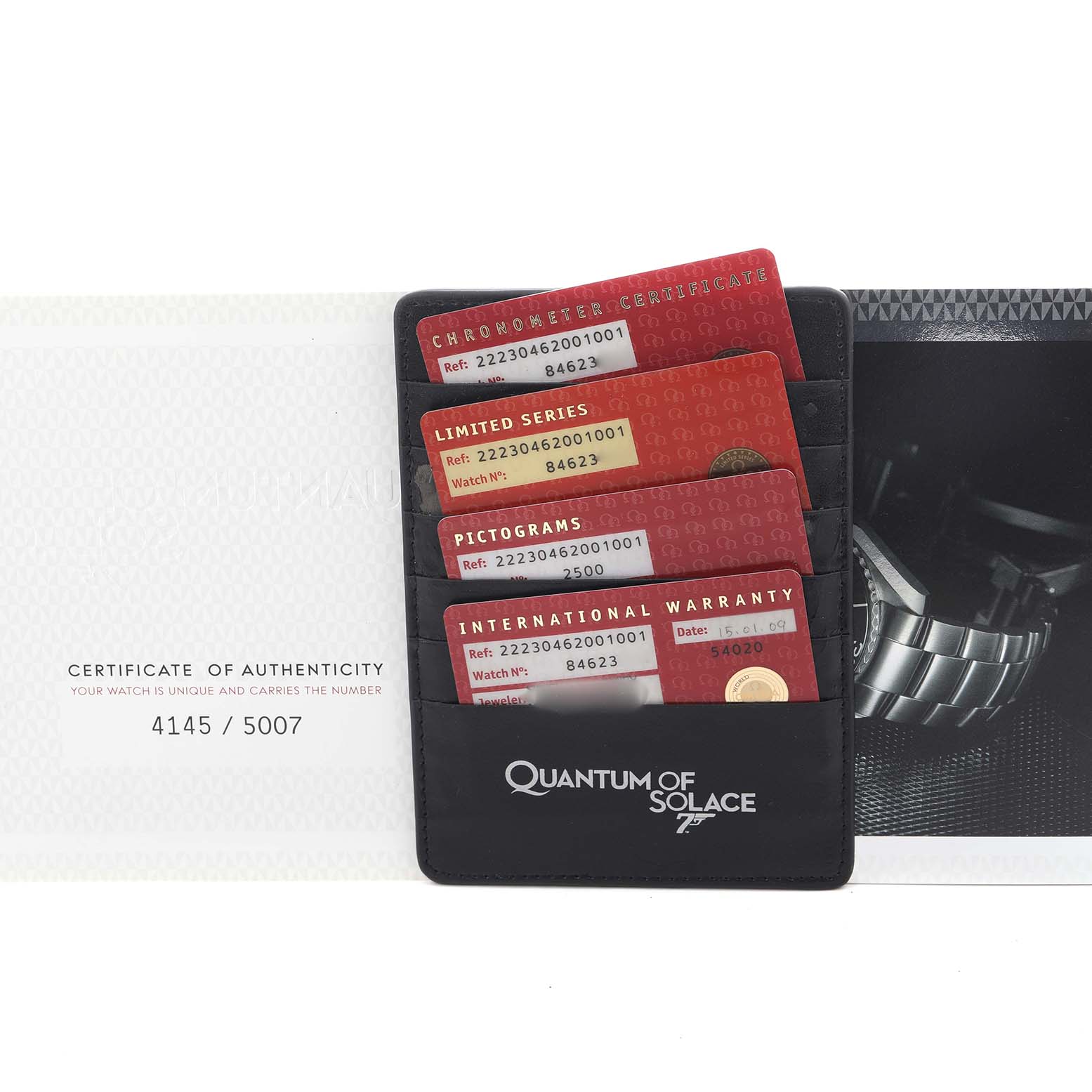 The image shows Omega Planet Ocean 222.30.46.20.01.001 Men's Stainless Steel Black Dial 222.30.46.20.01.001 Men's Stainless Steel Black Dial accessories, including a certificate, warranty cards, and a partial watch bracelet.