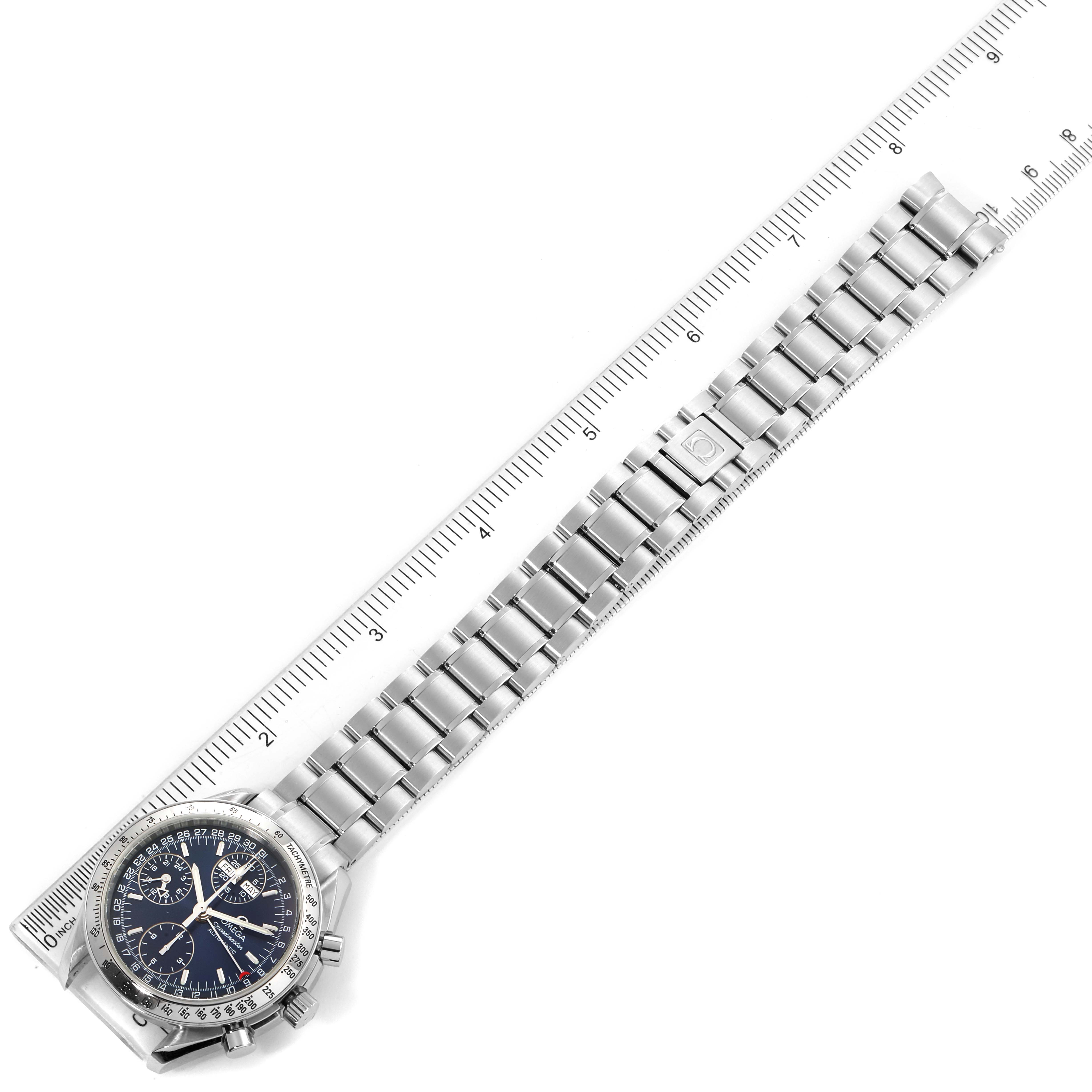 The Omega Speedmaster 3523.80.00 Men
s Stainless Steel Blue Dial 3523.80.00 Men
s Stainless Steel Blue Dial watch is shown from an overhead angle, displaying its full bracelet and dial beside a ruler.