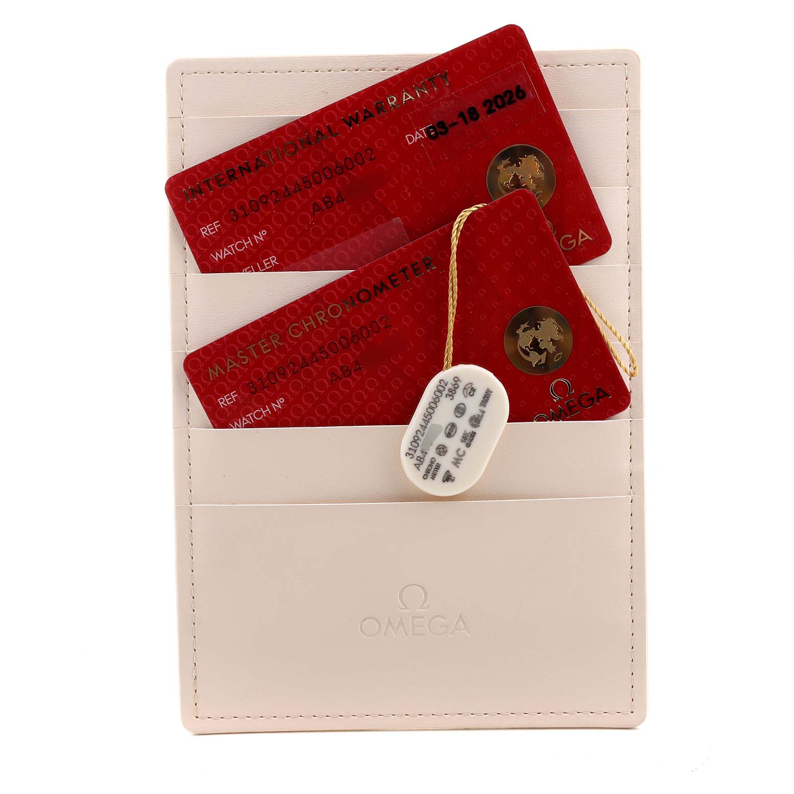 The image shows Omega Speedmaster 310.92.44.50.06.002 Men's Ceramic Grey Dial warranty cards and a chronometer tag within a cream cardholder.