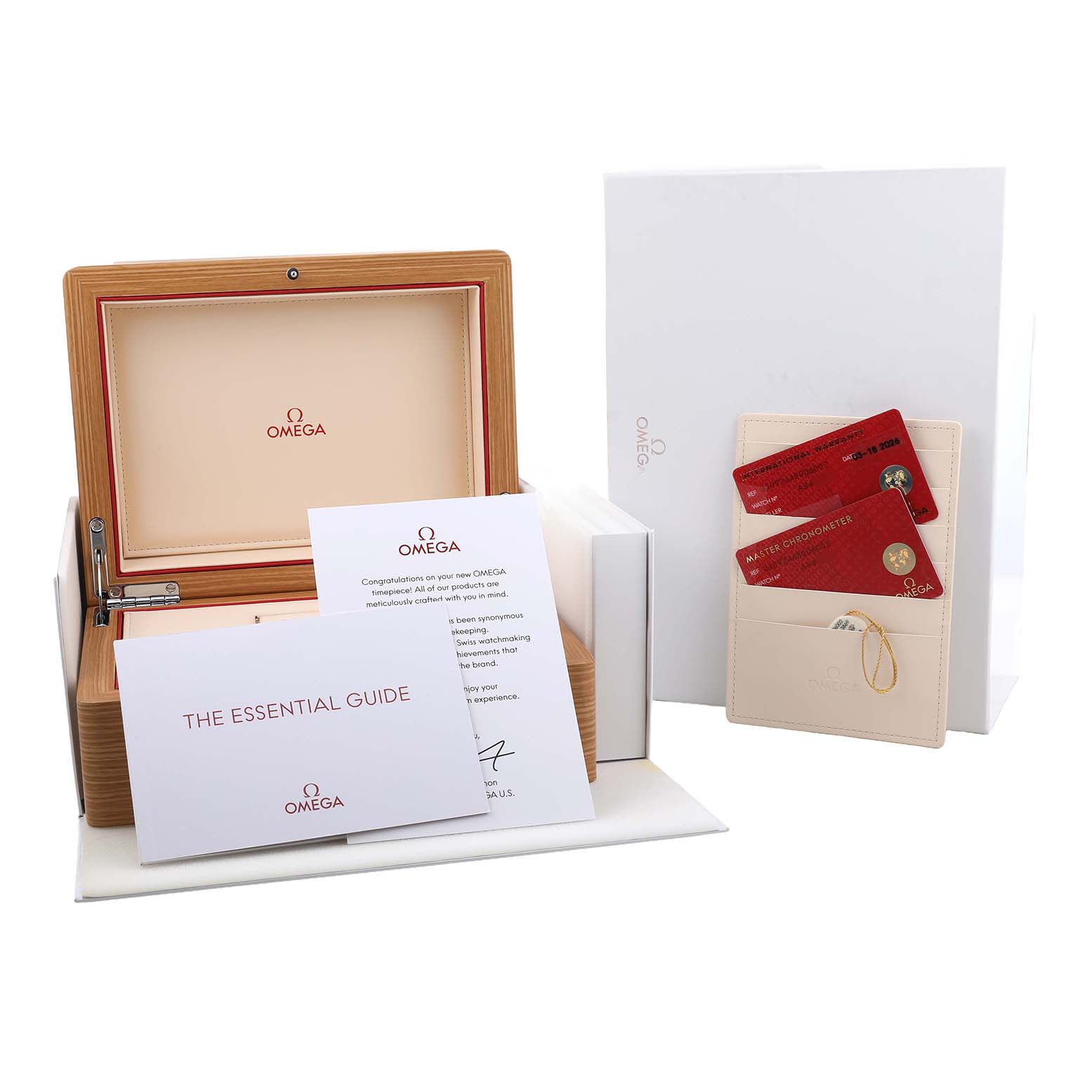 The image shows the packaging and documentation for an Omega Speedmaster 310.92.44.50.06.002 Men's Ceramic Grey Dial, including a box, essential guide, and warranty cards.