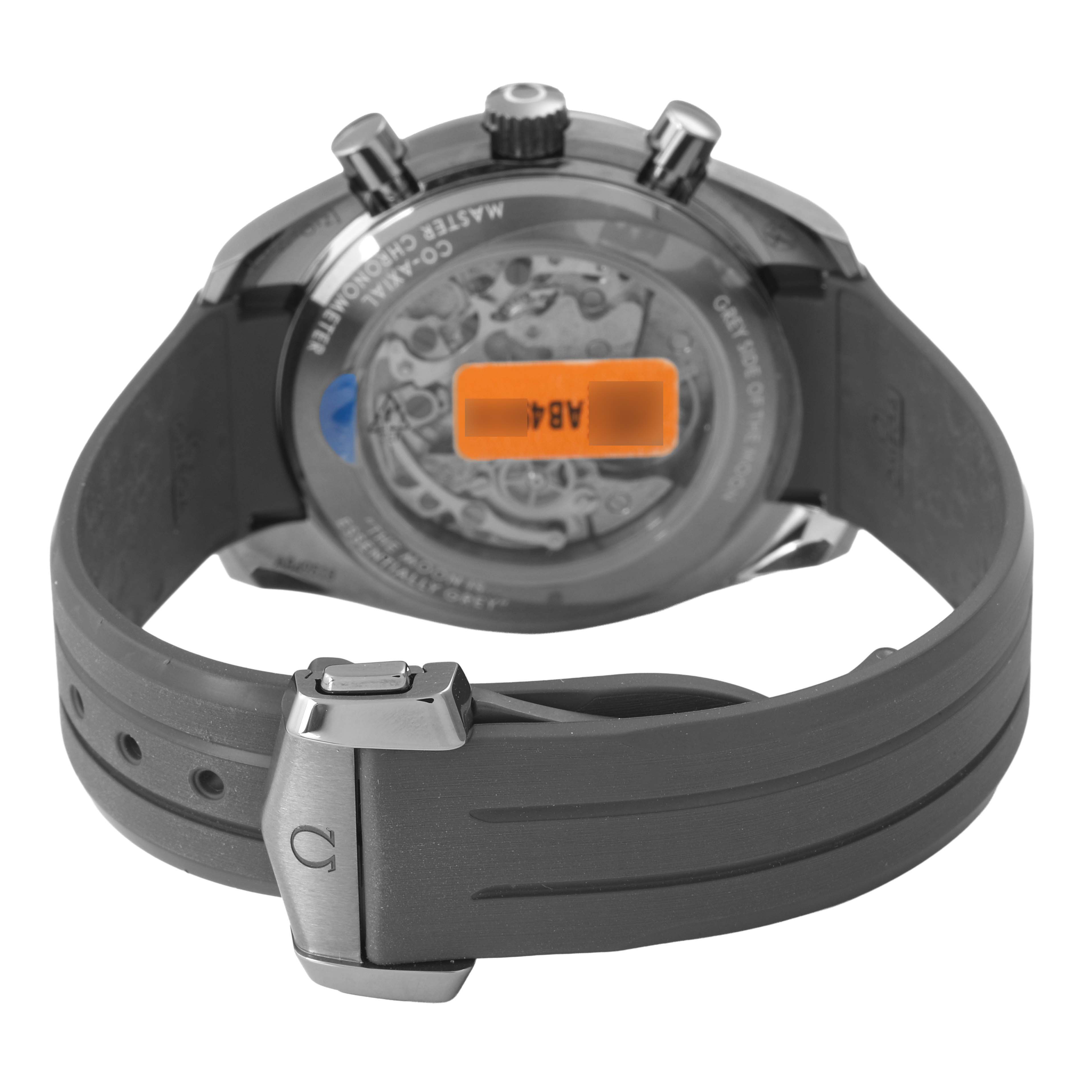 The Omega Speedmaster 310.92.44.50.06.002 Men's Ceramic Grey Dial watch is shown from the back, highlighting the clasp, strap, and transparent case back revealing the movement.