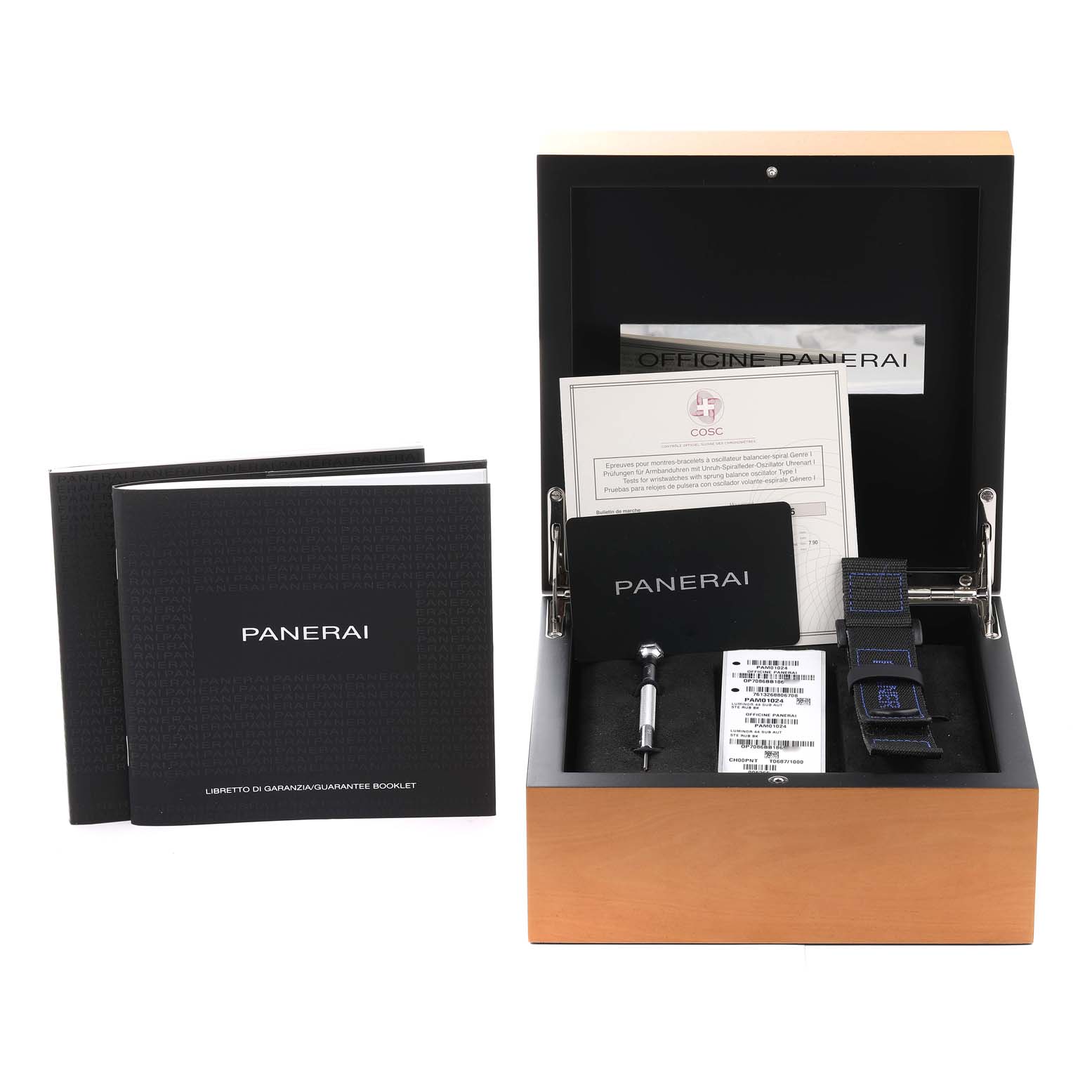 The image shows an open Panerai Submersible PAM01024 Men
s Stainless Steel Black Dial PAM01024 Men
s Stainless Steel Black Dial watch box with accessories, including booklets, screwdriver, strap, and warranty cards.