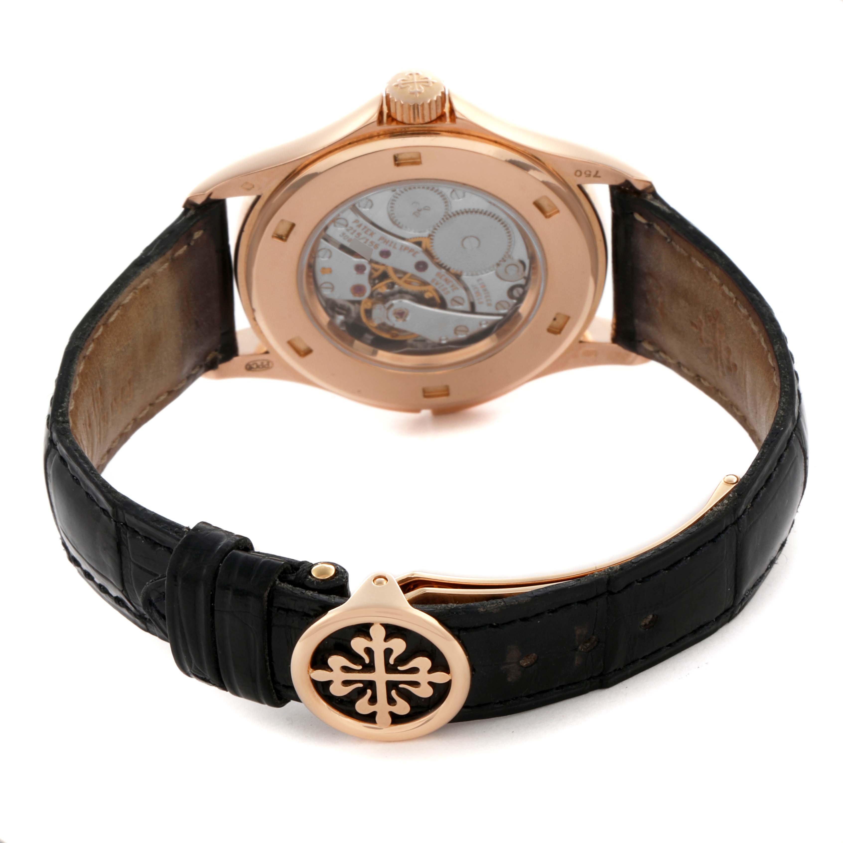 The image shows a Patek Philippe Calatrava 5134R-001 Men's Rose Gold White Dial 5134R-001 Men's Rose Gold White Dial watch from the back, highlighting the case back, movement, and leather strap with a clasp.