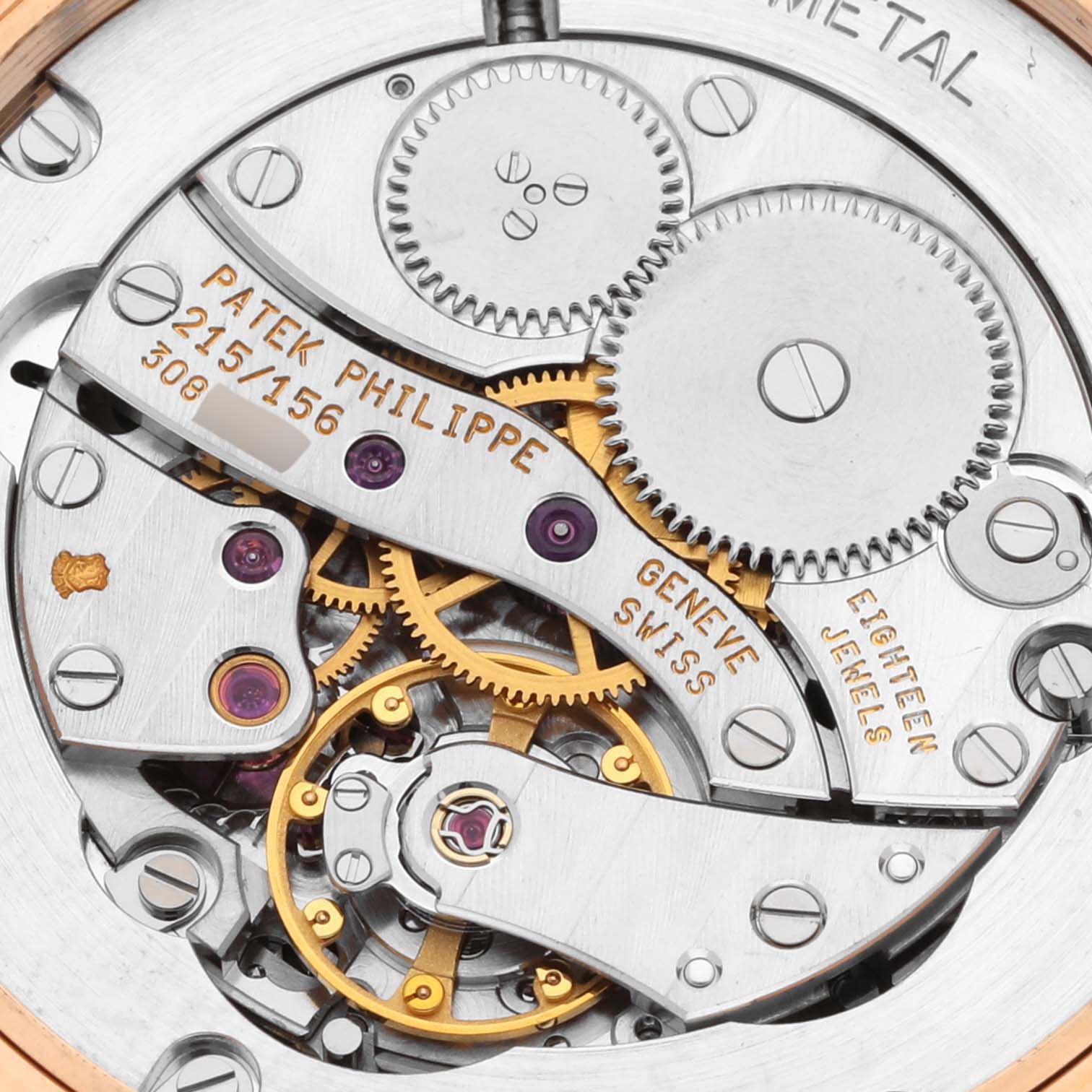 The image shows a close-up of the Calatrava model by Patek Philippe, focusing on the intricate movement with gears and inscriptions.