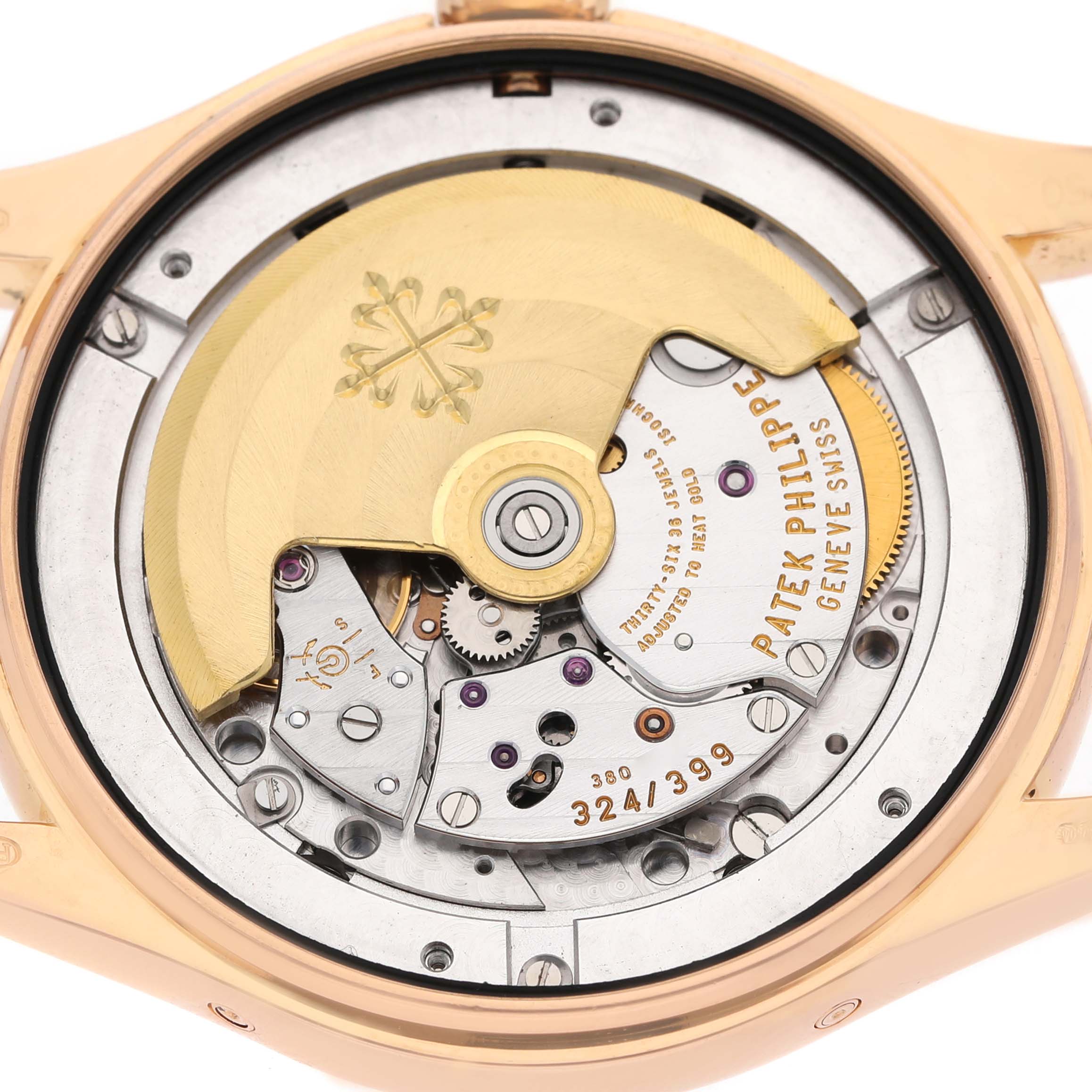 The image shows the back view of the Patek Philippe Complications 5146R-001 Men's Rose Gold Beige Dial model, highlighting its intricate movement and rotor.