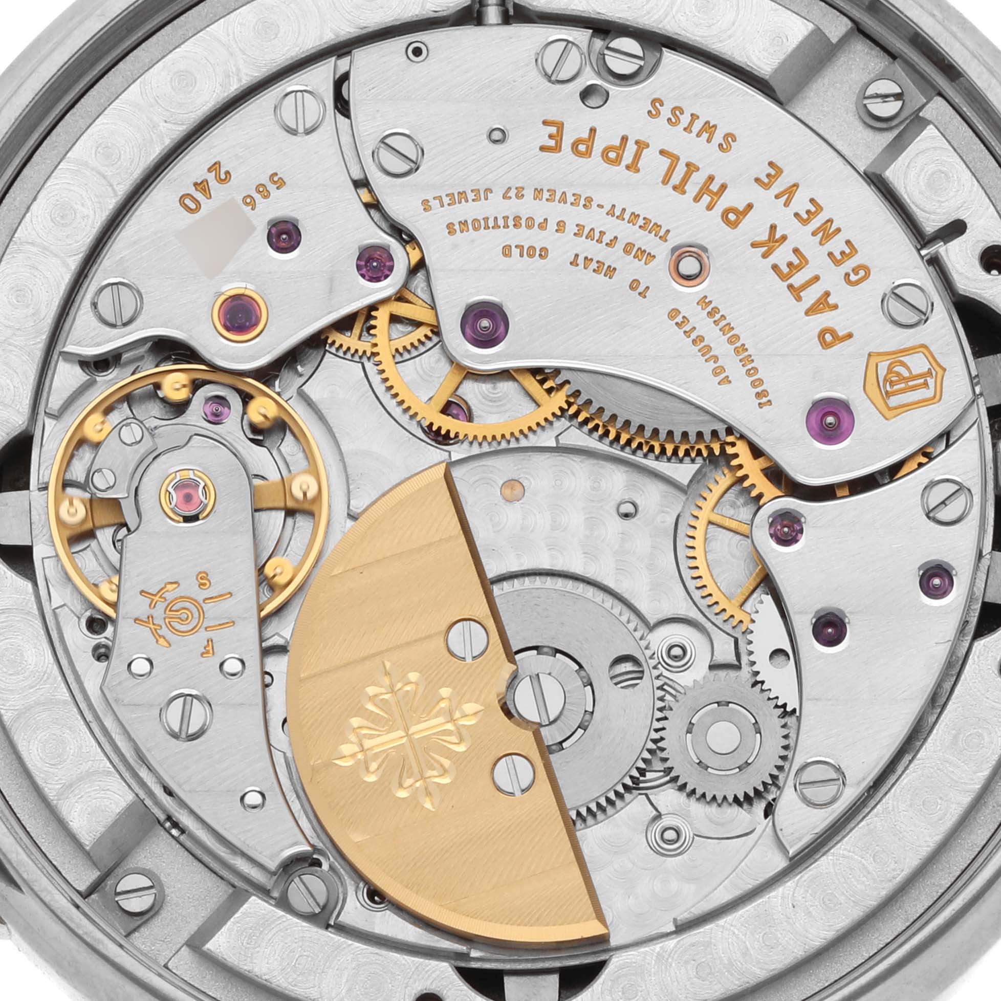 The image shows the movement of a Patek Philippe Complications 5139G Men's White Gold Black Dial 5139G Men's White Gold Black Dial watch, highlighting gears and the rotor from a top-down view.