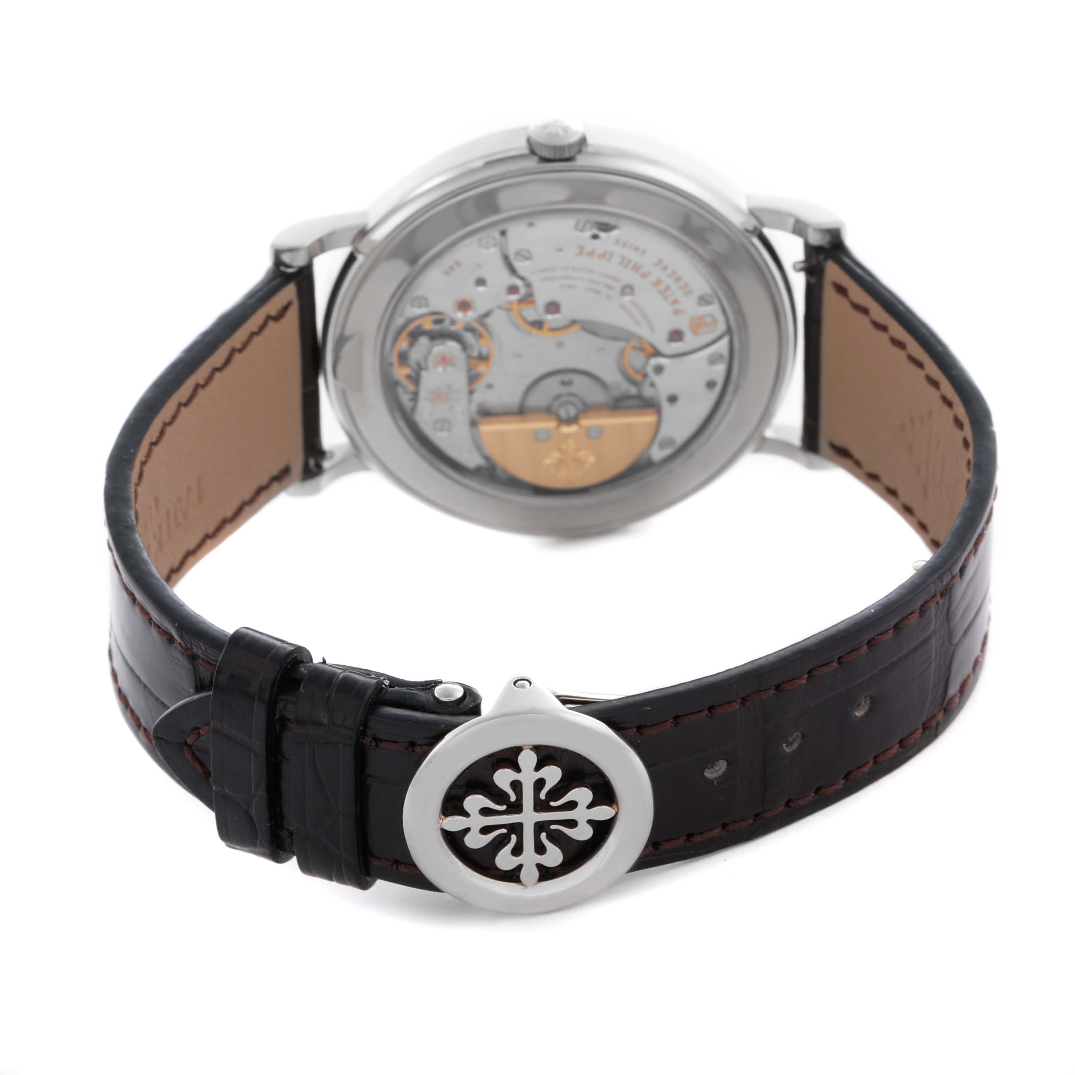 The Patek Philippe Complications 5139G Men's White Gold Black Dial 5139G Men's White Gold Black Dial watch is shown from the back, displaying its movement and the leather strap buckle.