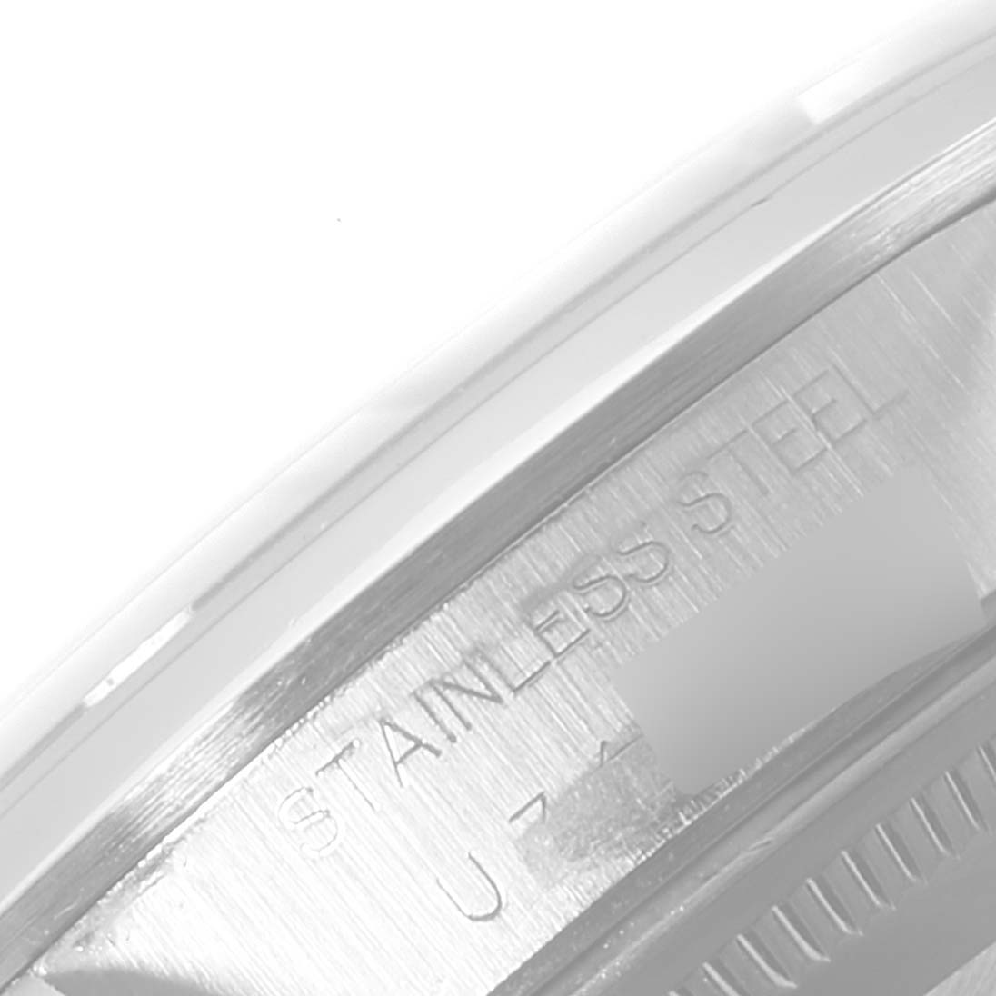 This image shows a close-up of the stainless steel case back edge of a Rolex Air-King 14000 Men's Stainless Steel Pink Dial 14000 Men's Stainless Steel Pink Dial watch, highlighting the engraved text.