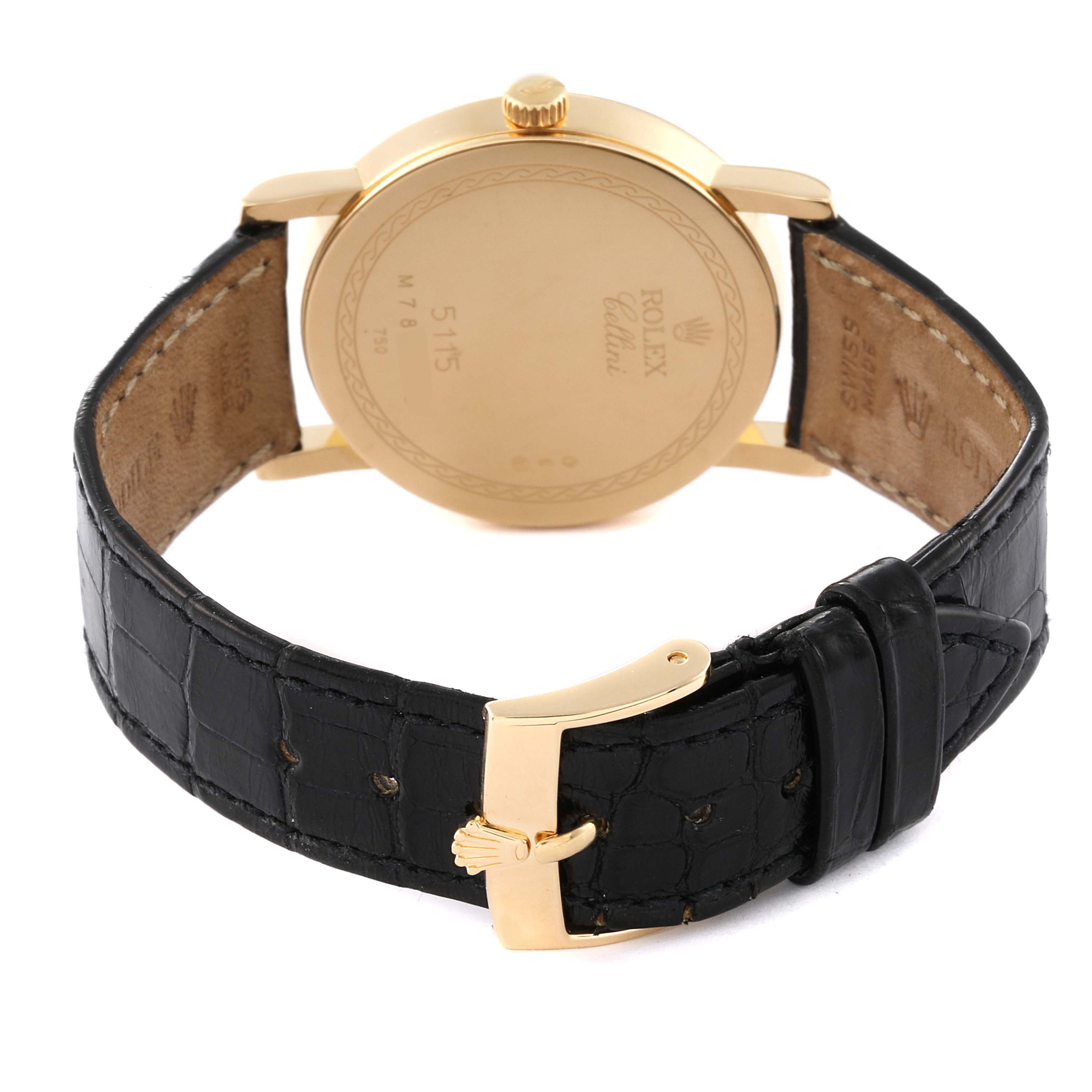 The image shows the back of a Rolex Cellini 5115/8 Men's Yellow Gold Beige Dial 5115/8 Men's Yellow Gold Beige Dial watch, highlighting its gold case and black leather strap with a gold buckle.