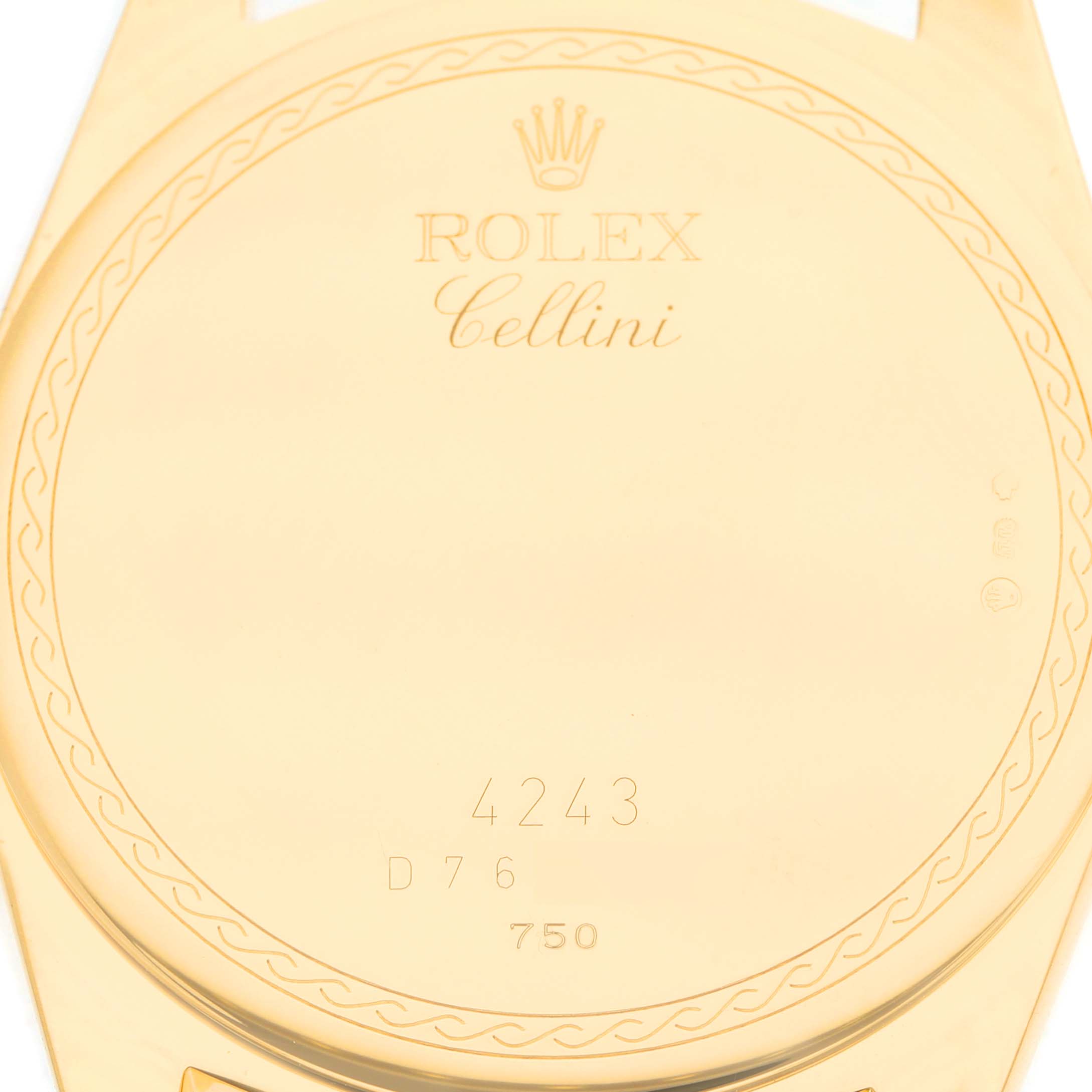 The image shows the back case of a Rolex Cellini 4243 Men's Yellow Gold Champagne Dial watch with engravings and a patterned edge.