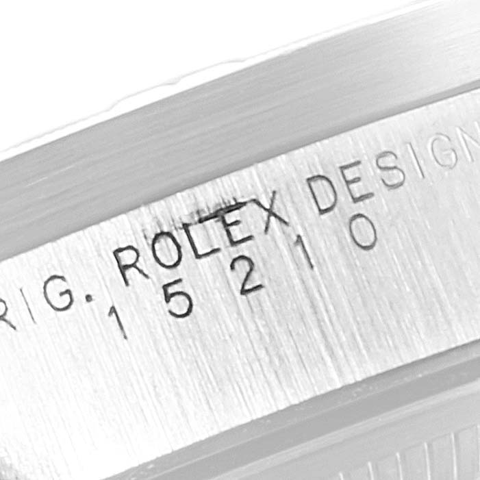 The image shows the side of the Rolex Date 15210 Men's Stainless Steel Silver Dial 15210 Men's Stainless Steel Silver Dial model watch case, highlighting the engraved design number.