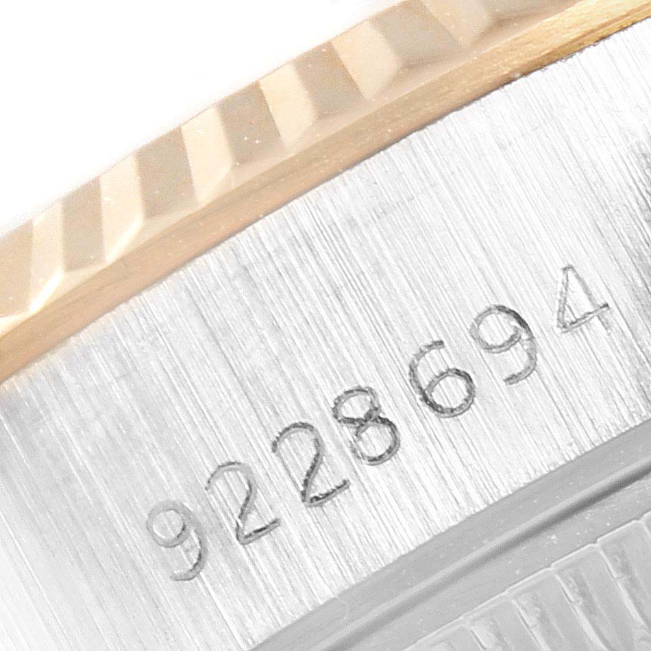 The image shows a close-up of the serial number and fluted bezel of a Rolex Datejust 69173  Women's Stainless Steel Champagne Dial 69173  Women's Stainless Steel Champagne Dial watch.