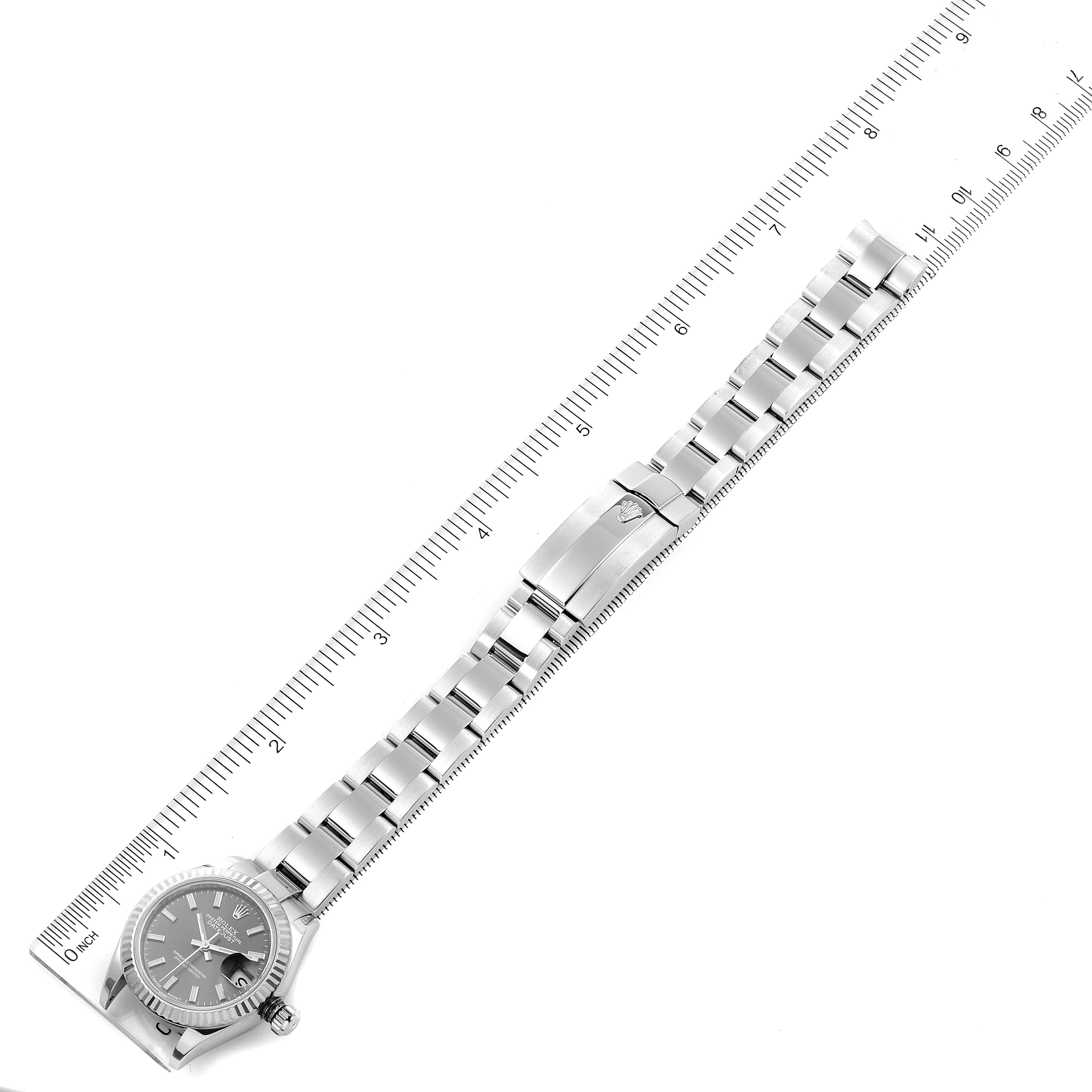 This image shows a top-down view of a Rolex Datejust 279174 Women's Stainless Steel Grey Dial 279174 Women's Stainless Steel Grey Dial watch, including the case, dial, bracelet, and clasp, alongside a ruler for scale.