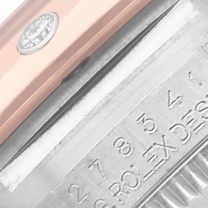 The image shows a close-up of the side of a Rolex Mid-Size 278241 Women's Steel and Gold (two tone) Pink Dial 278241 Women's Steel and Gold (two tone) Pink Dial watch, highlighting the edge detailing and engraved text.