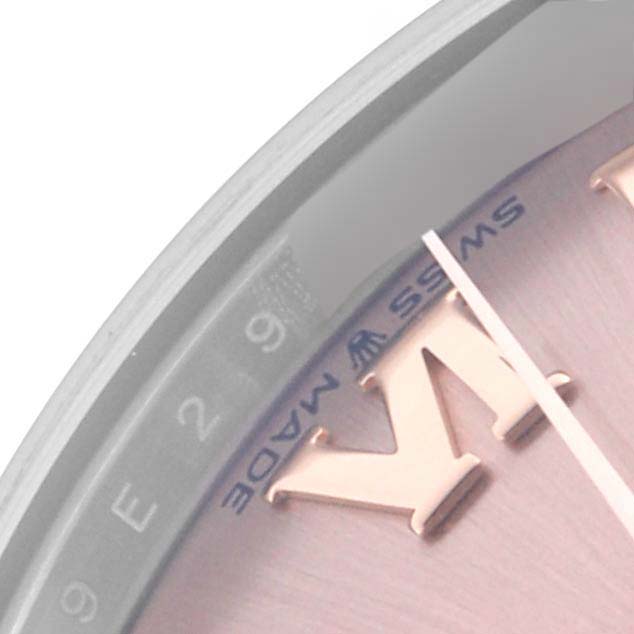 The image shows a close-up of a Rolex Mid-Size 278241 Women's Steel and Gold (two tone) Pink Dial watch face, highlighting the bezel and dial details at an oblique angle.